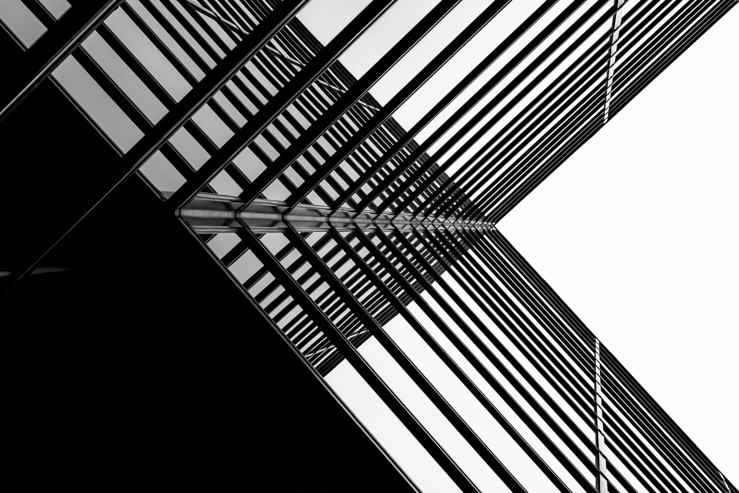 Upward view of a high-rise steel and glass facade — operational counterpart to architects and designers on hospitality projects.
