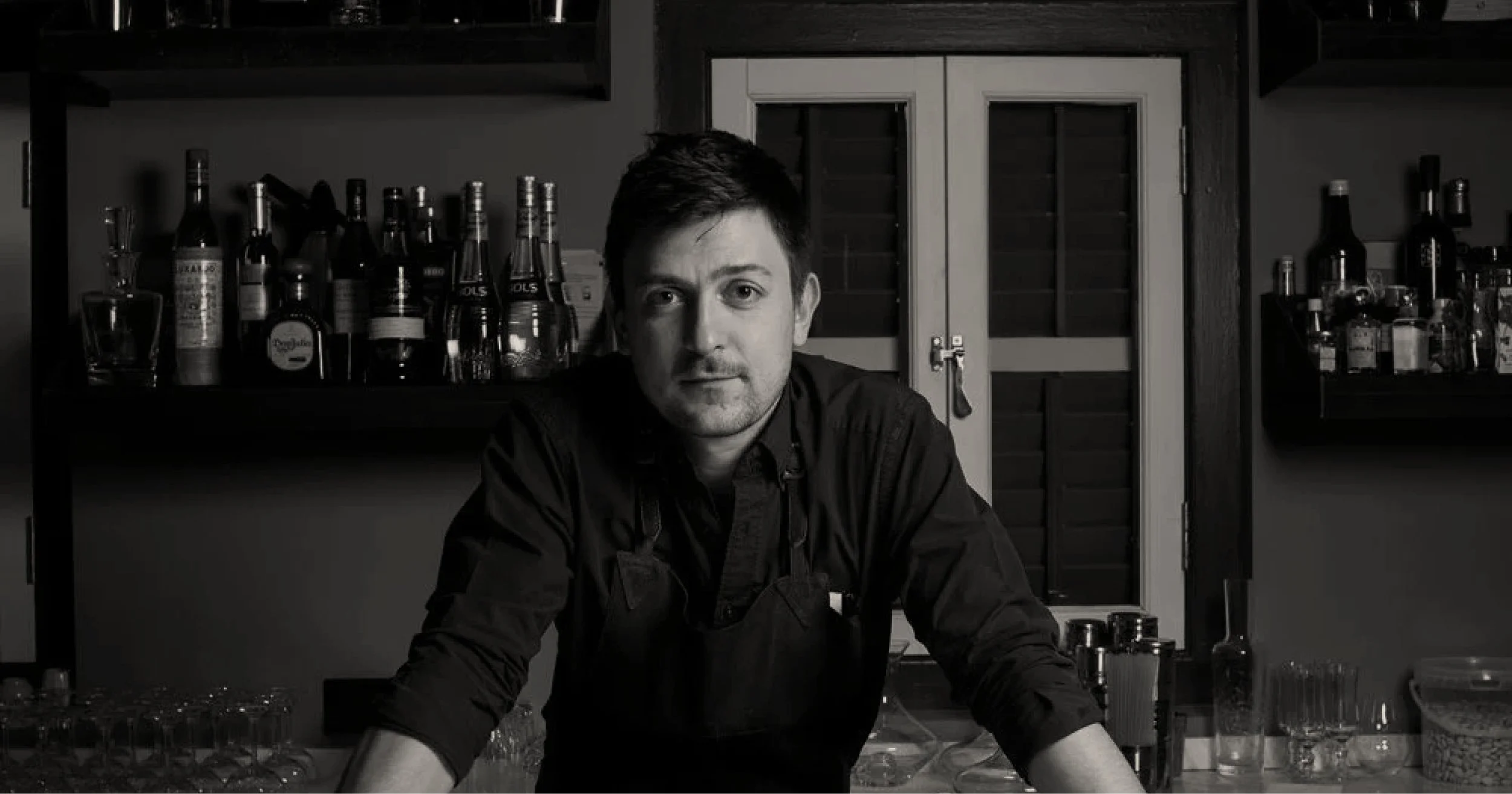 Kamil Foltan, independent hospitality design and operations advisor, photographed behind a bar.