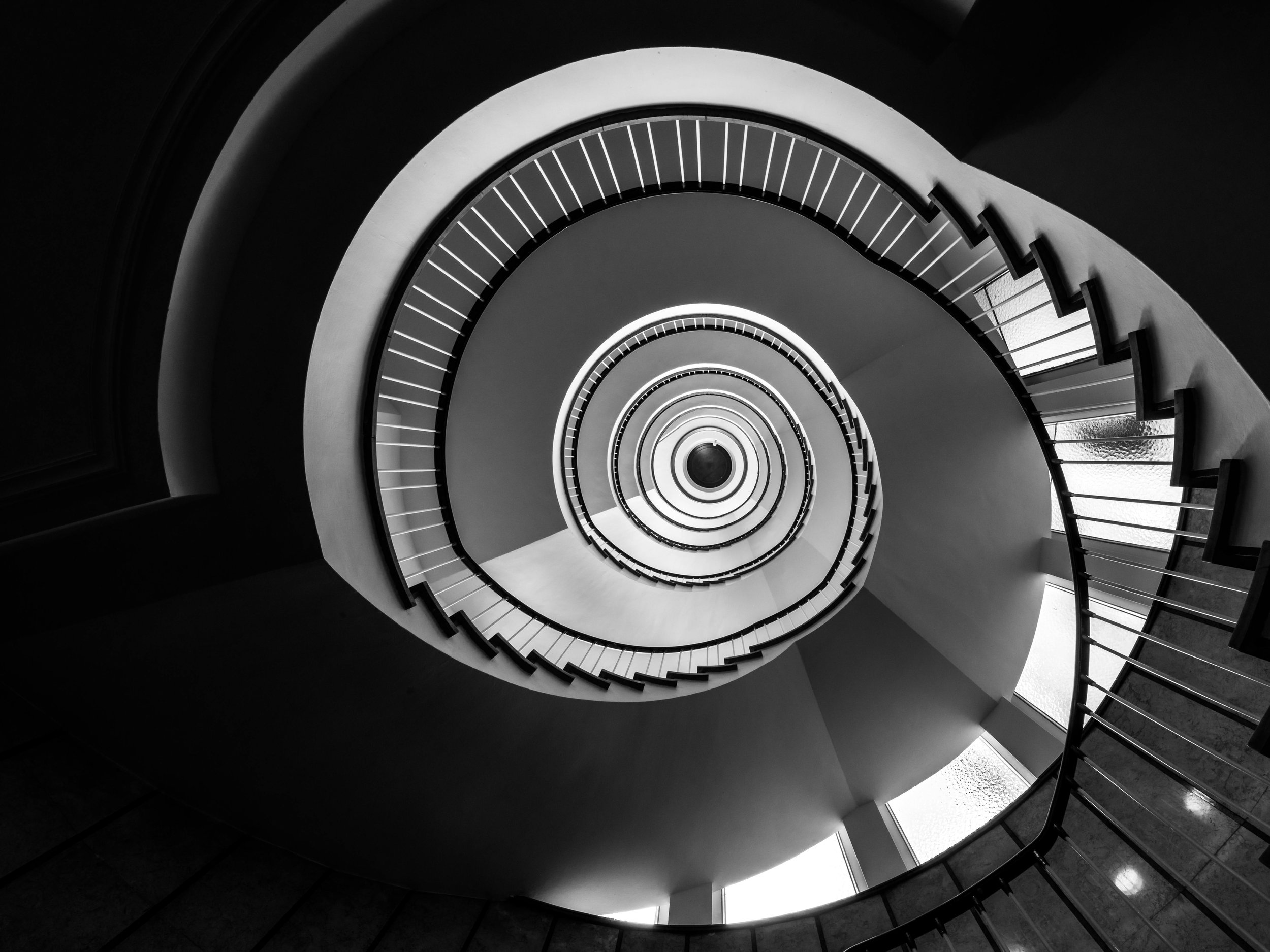 Heritage spiral staircase — Kamil Foltan brings architectural reading and operational experience to hospitality advisory.