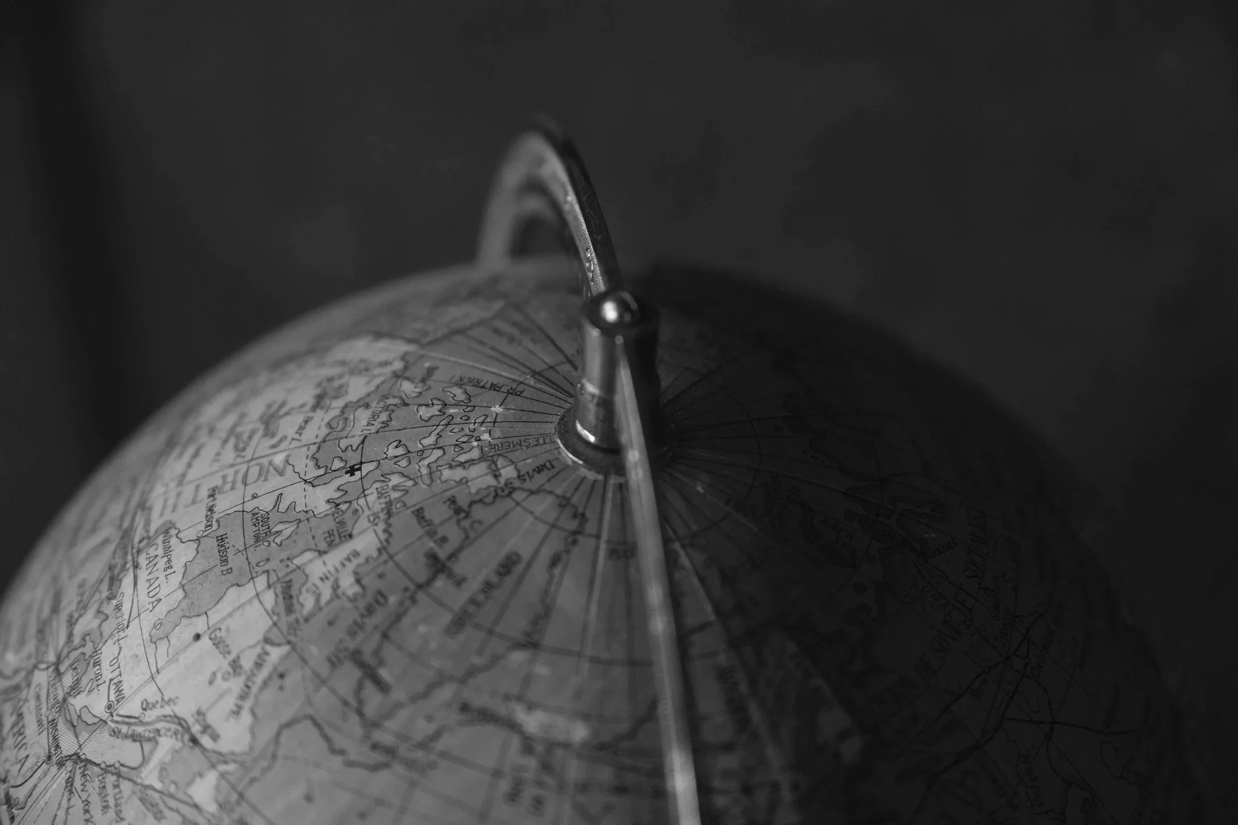 Vintage globe detail — Kamil Foltan's hospitality career across Sydney, Singapore, Bali, London and Prague.