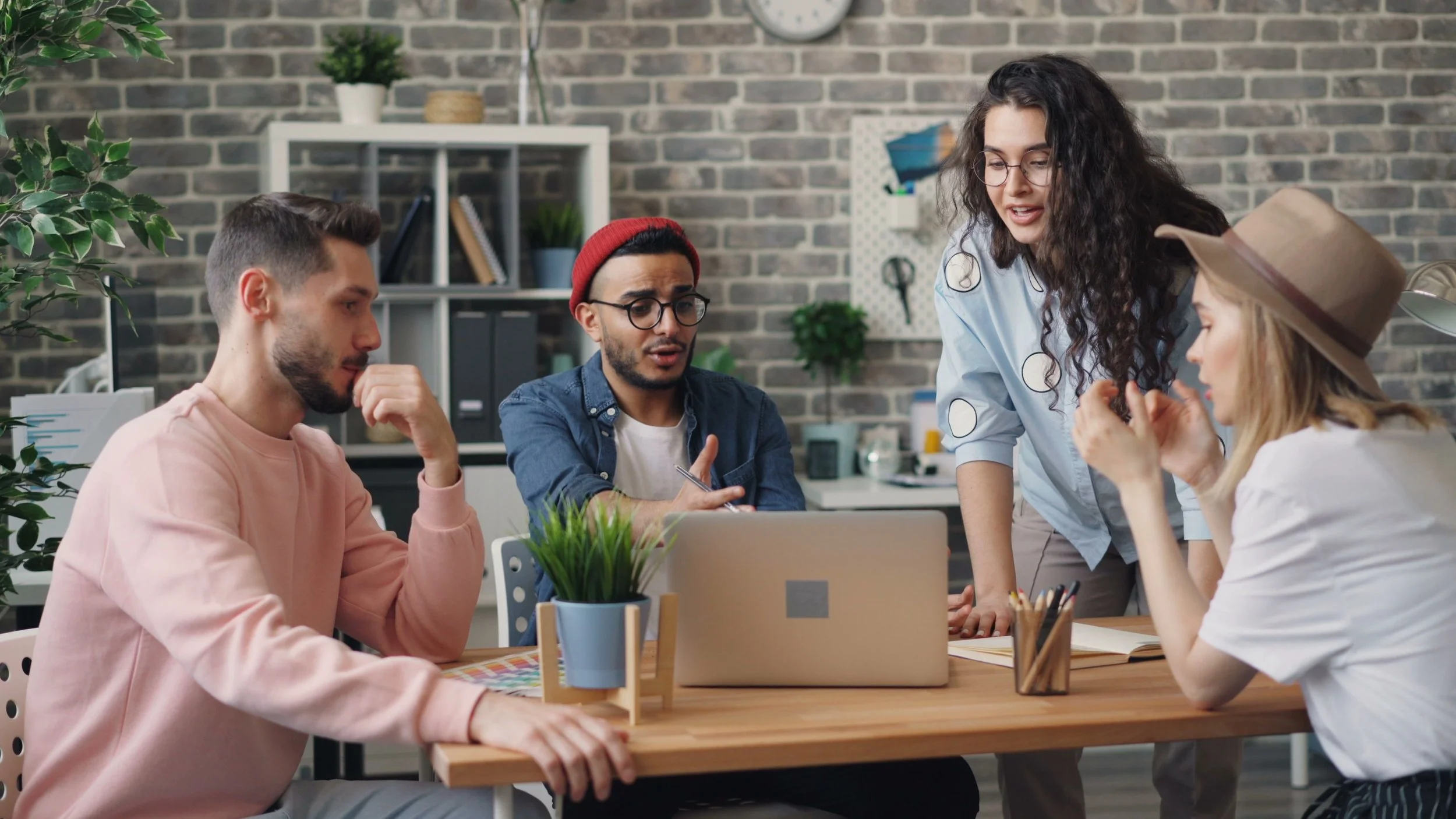 Growing startup team collaborating on technology and business operations in a modern office.