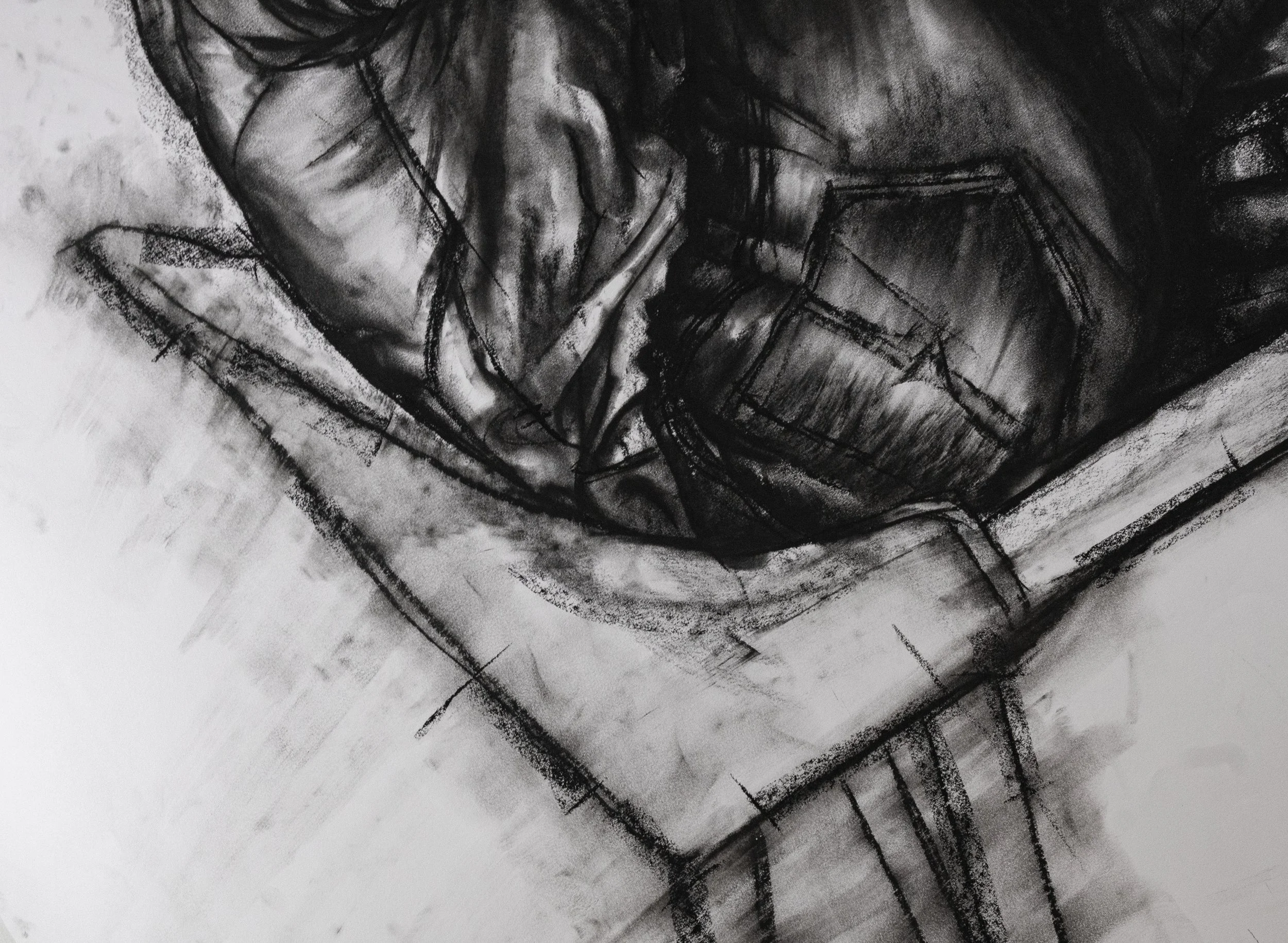 Black and white abstract drawing with bold, rough lines and shading, featuring a circular shape in the center.