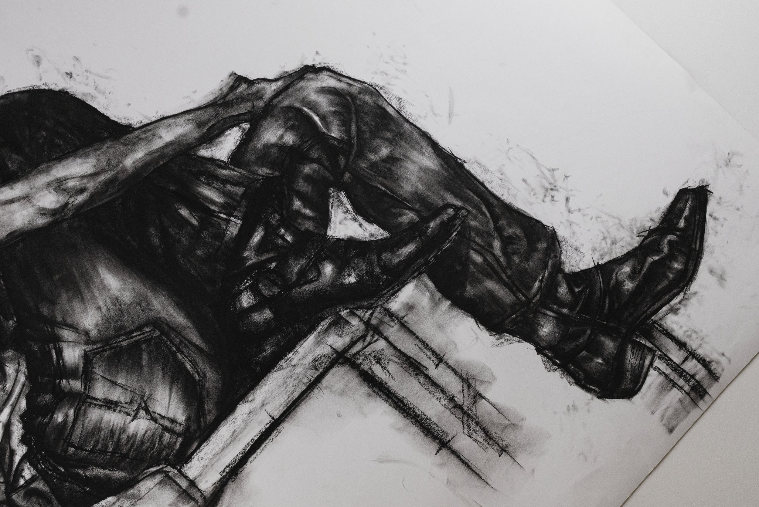 A black and white sketch of a person lying on a bed with their hands behind their head and a relaxed posture.
