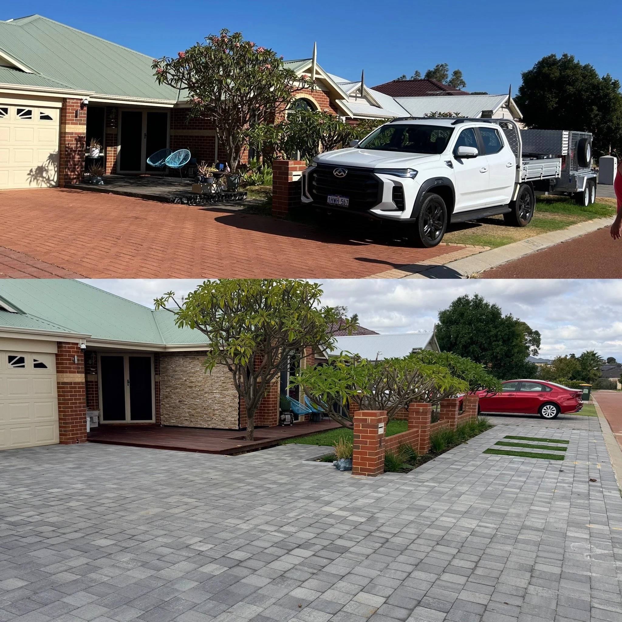 A house with a brick and stone exterior, a large driveway paved with gray bricks, a white pickup truck parked near the house, a tree with pink flowers, and a parking lot with a red car and a green trash bin in the background.