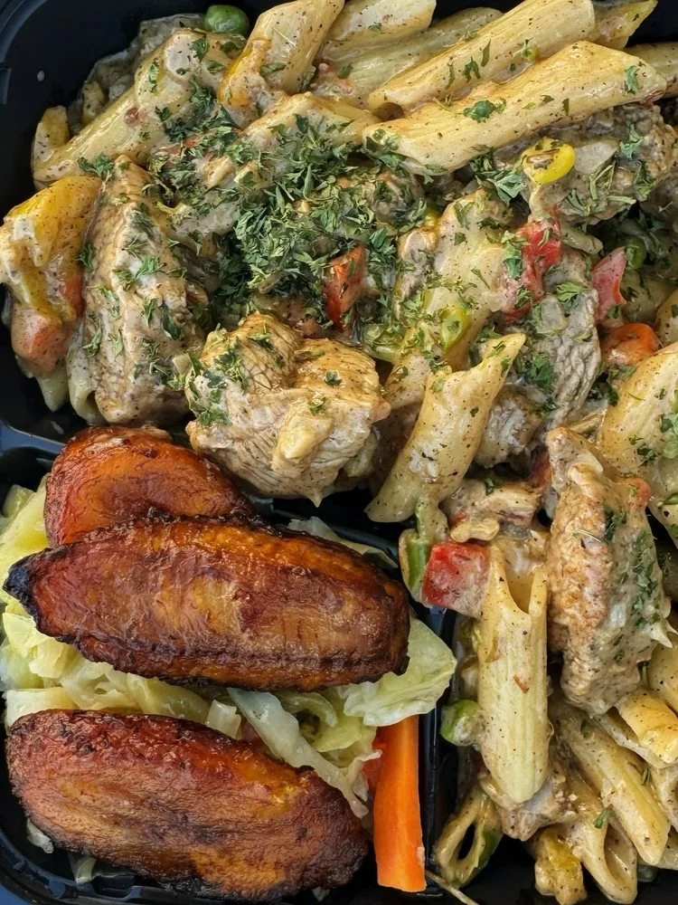 Mixed food plate with pasta, grilled chicken, and roasted plantains.