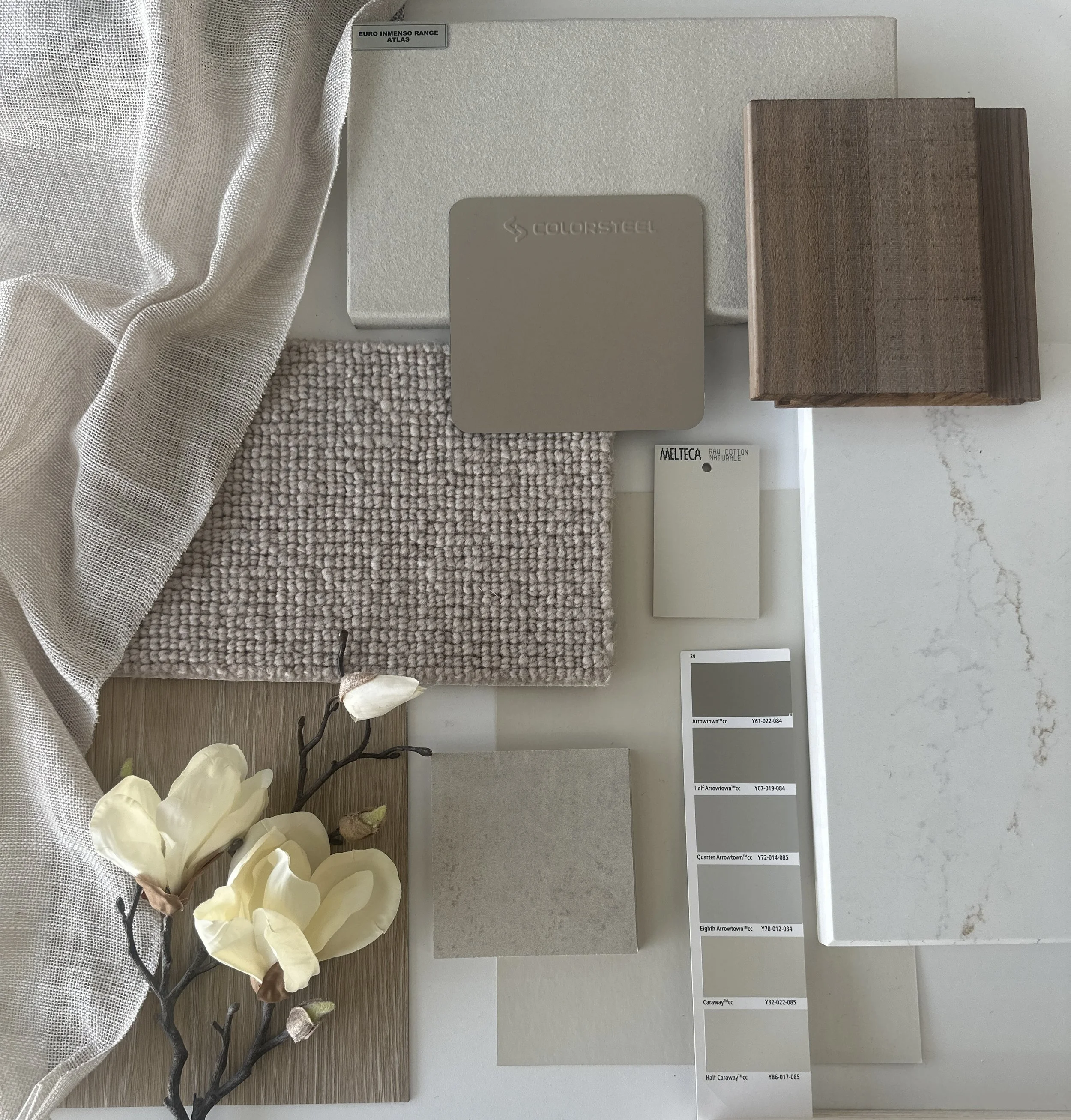 Samples of materials and color swatches for interior design, including fabric, paint colors, and wood finishes.