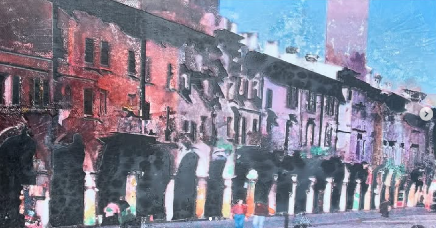 A colorful auditorium with a large mural of buildings on the wall, featuring arches, windows, and balconies, with people walking in front of it.