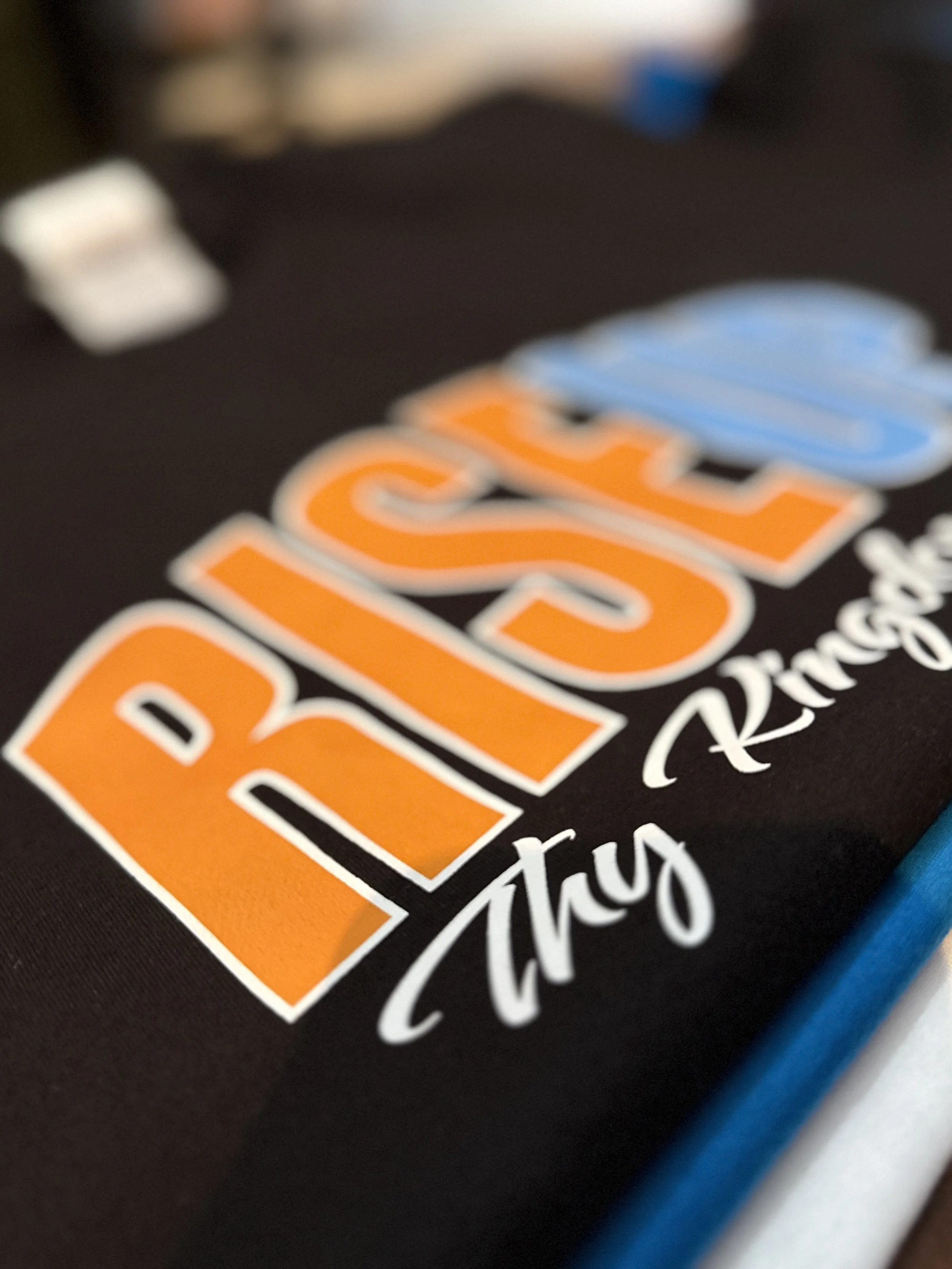 Close-up of a logo with text in orange and blue on a black background.