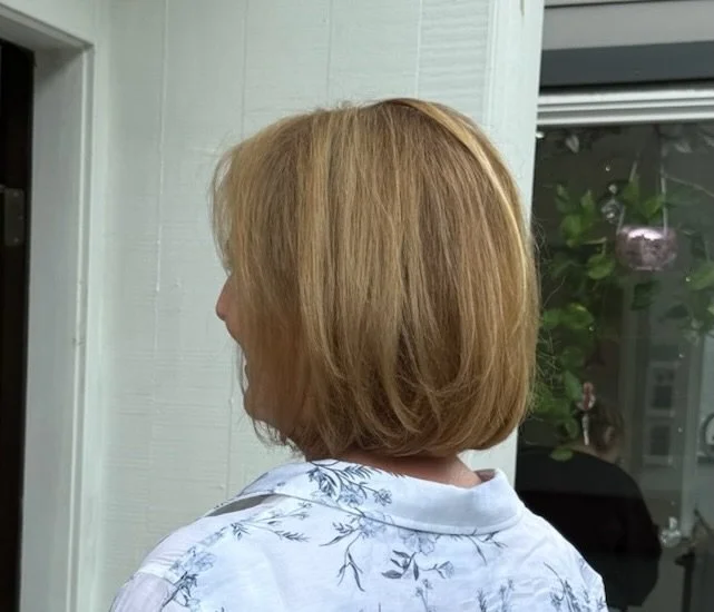 Tintcovers her grey coverage and a smoothing treatment refreshes the hair with a smooth, soft finish. Her highlights from a previous appointment shine through for depth and a natural looking appearance.