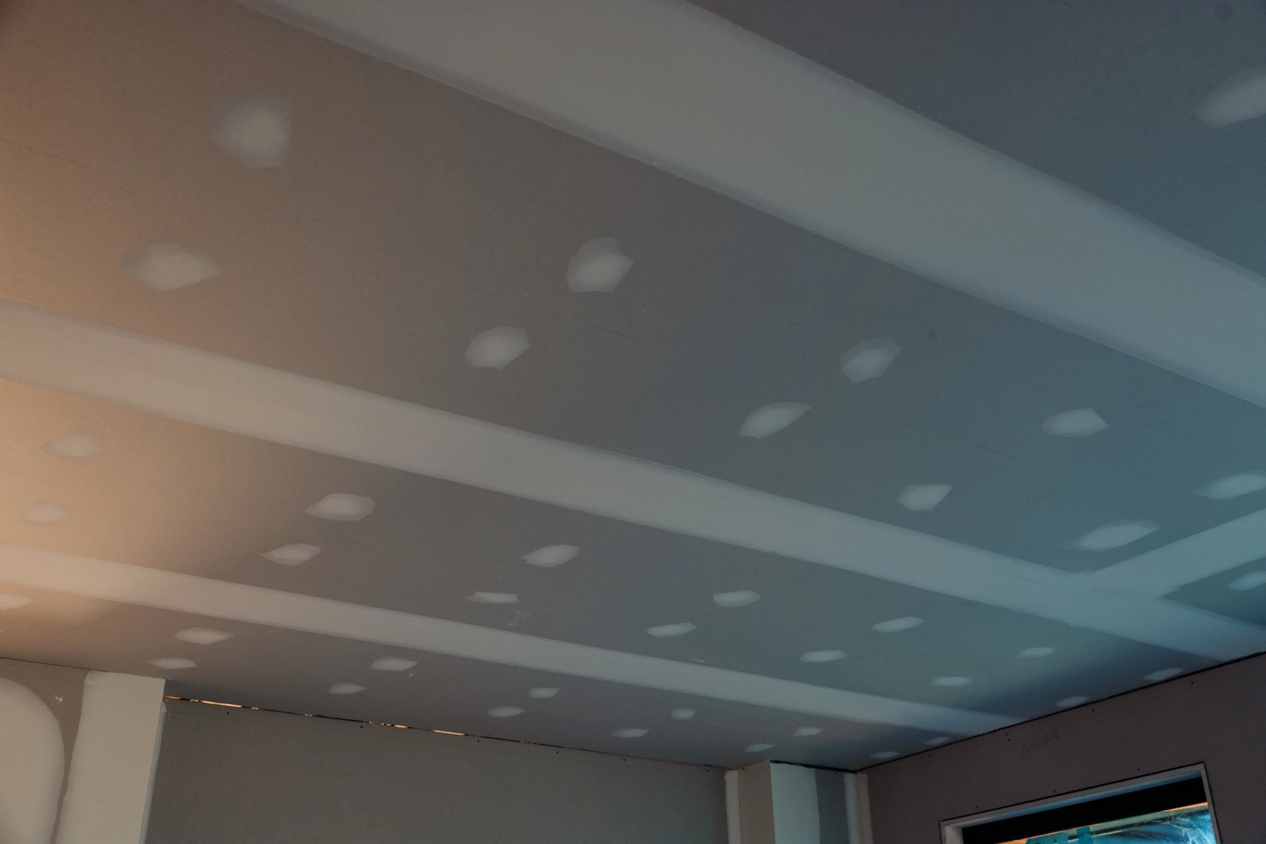 Ceiling with multiple recessed lights, with some lights turned off, in a modern interior space.