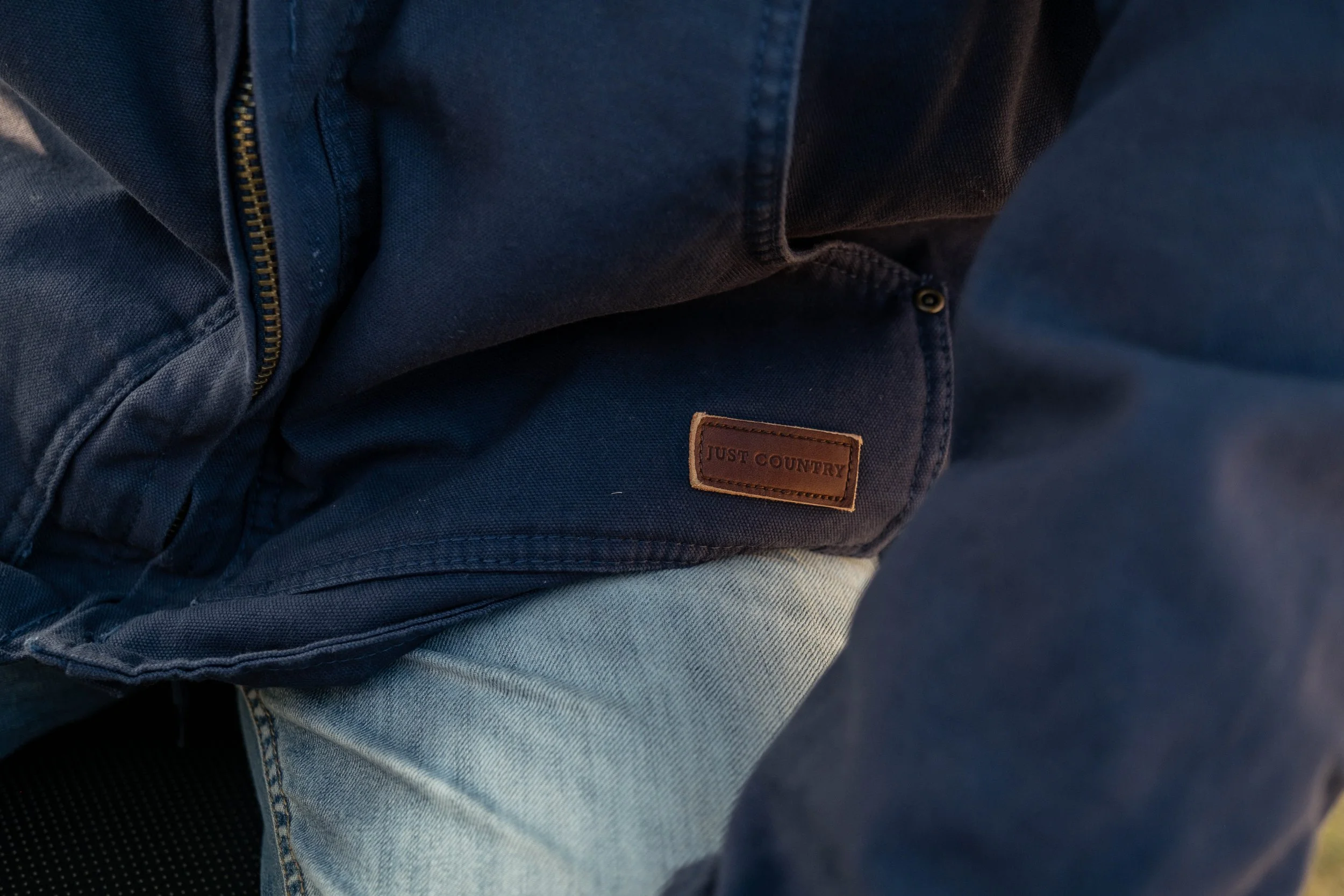 Just Country workwear detail photographed in a real working environment, highlighting durability, practicality and everyday use.