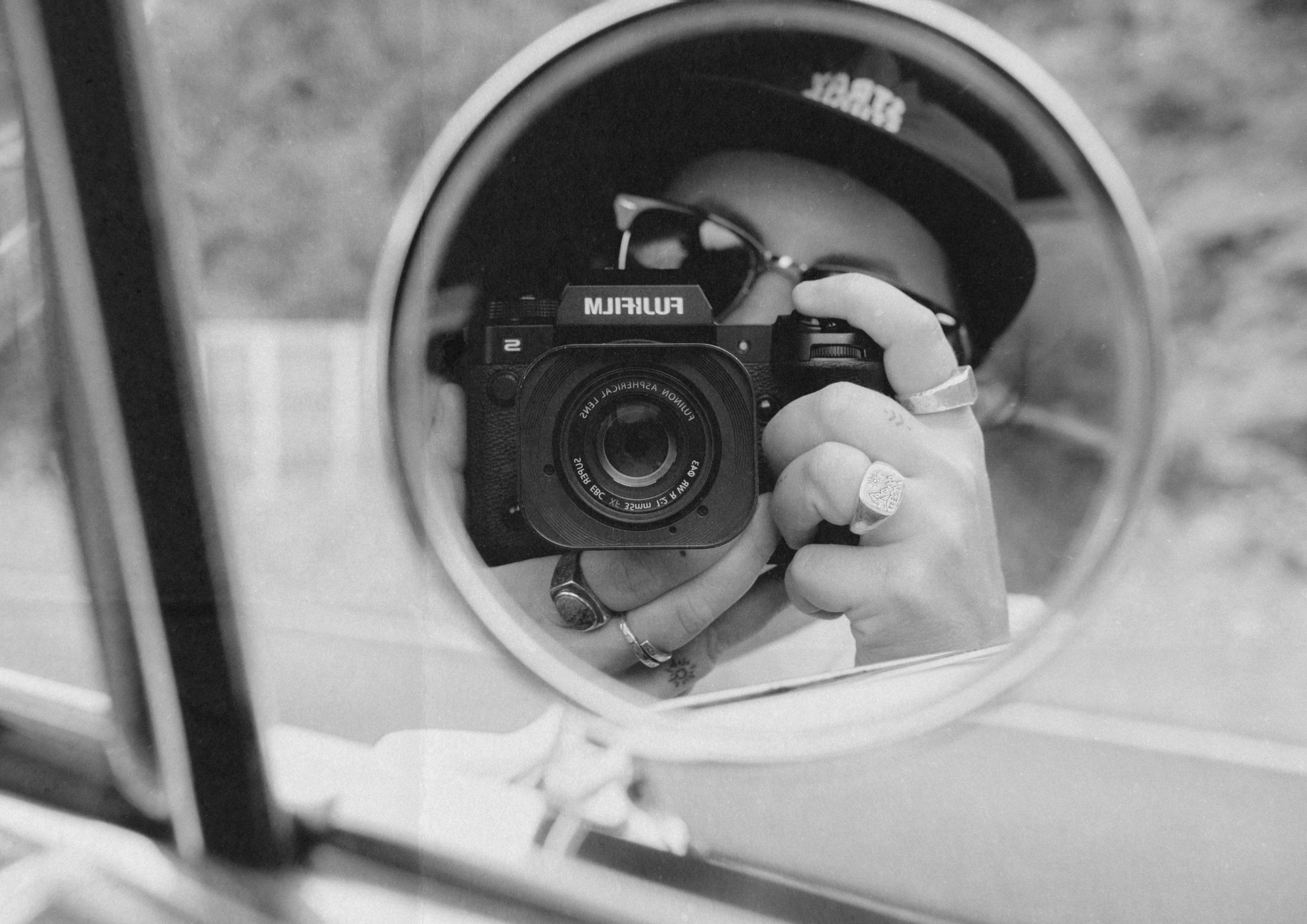 Photographer Nic Maloney taking a self portrait with a Fujifilm camera.