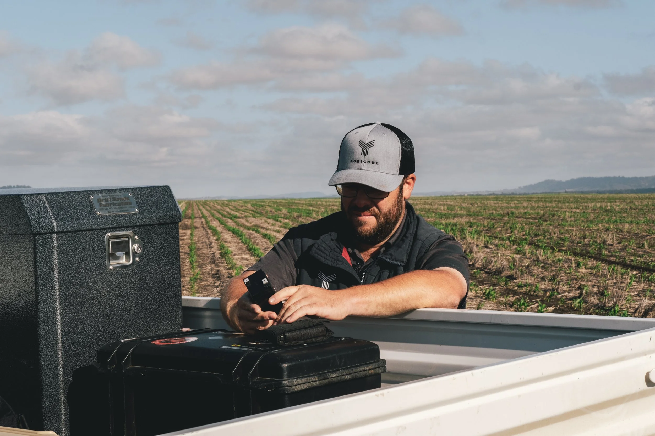 Agricore field technician preparing equipment for on-farm monitoring and data collection.