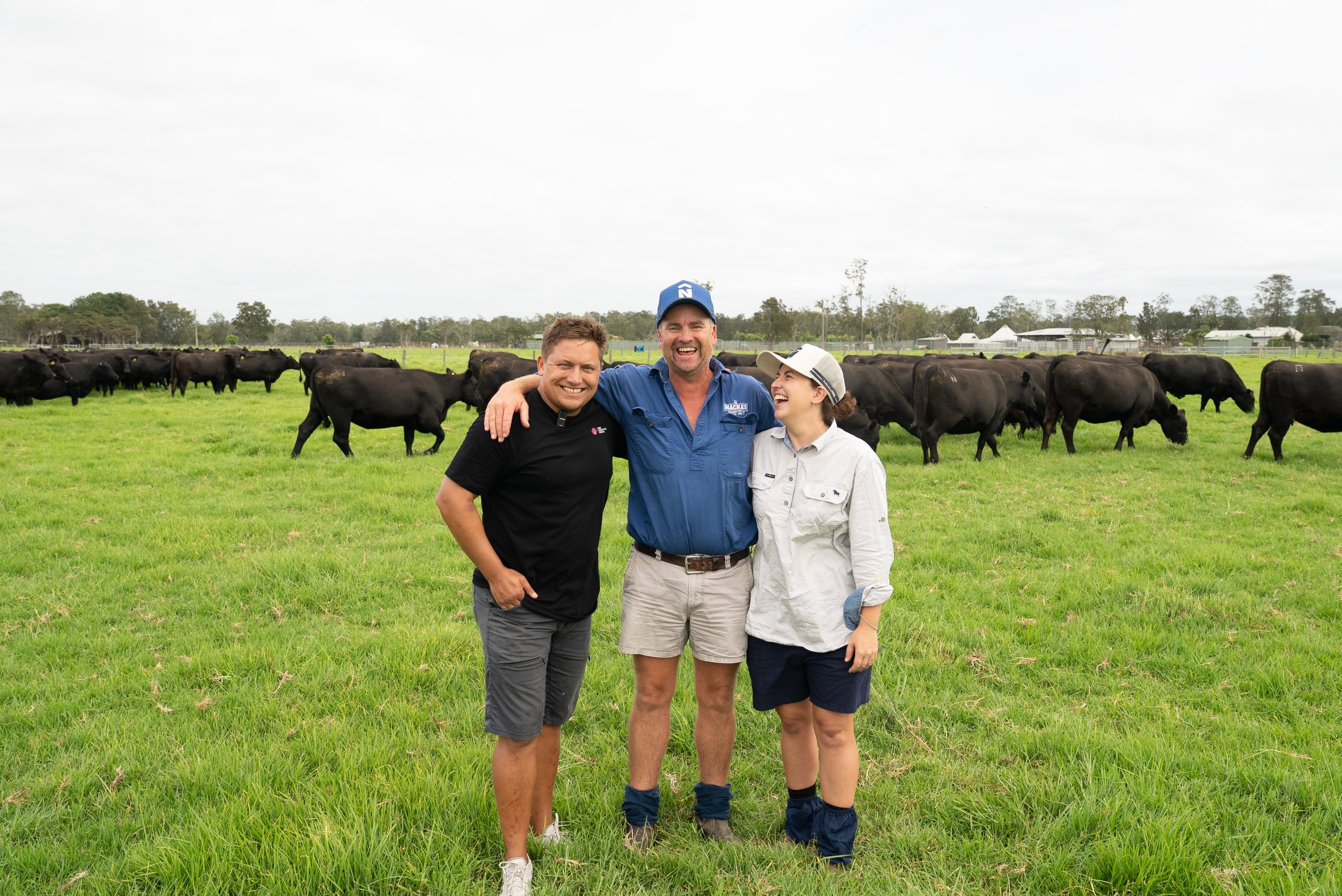 Members of the Mackenzie family standing among the cattle that reflect decades of breeding decisions and long-term commitment to the program.