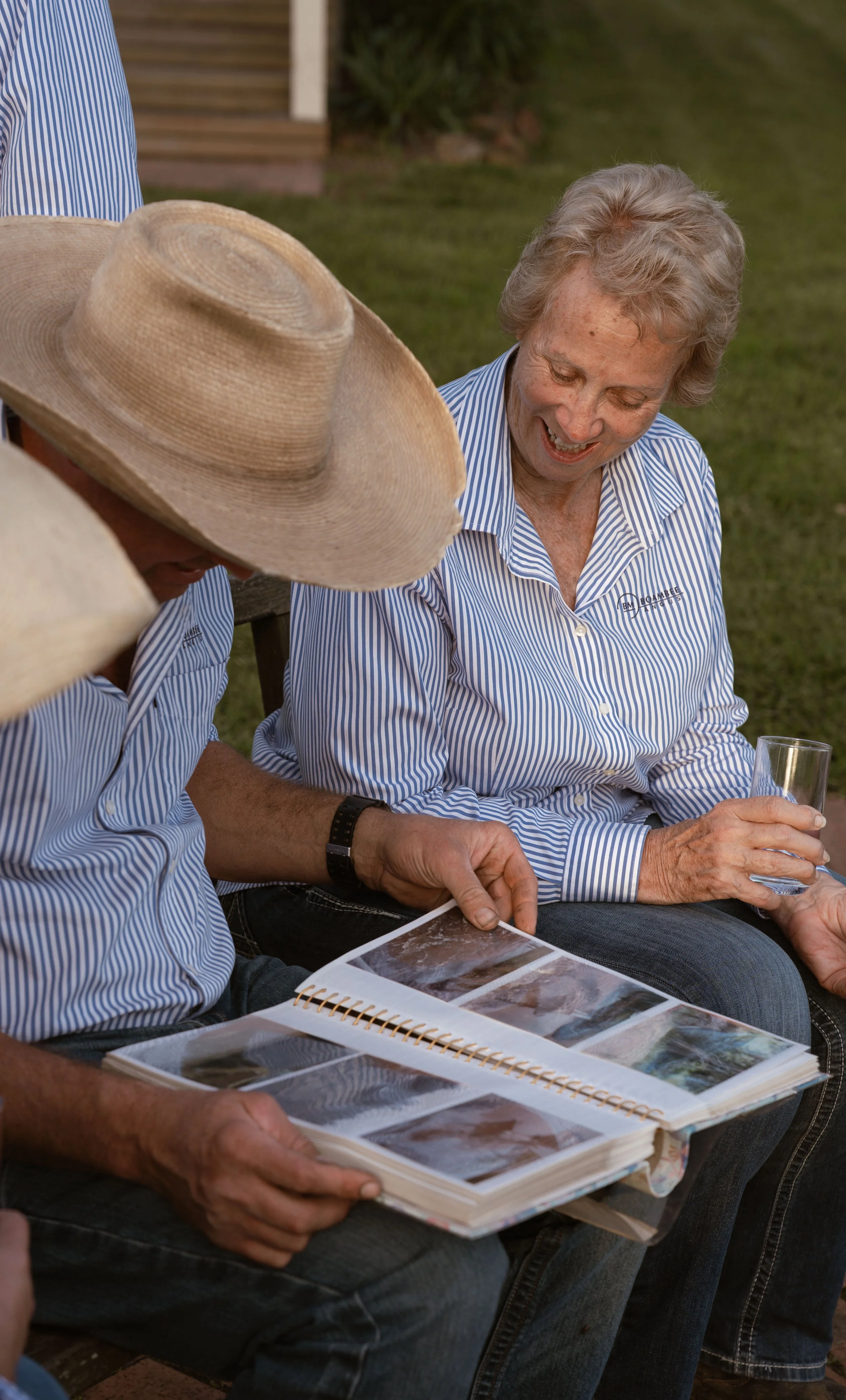 Boambee Angus family members sharing photographs and stories during filming for the Boambee Angus brand story.