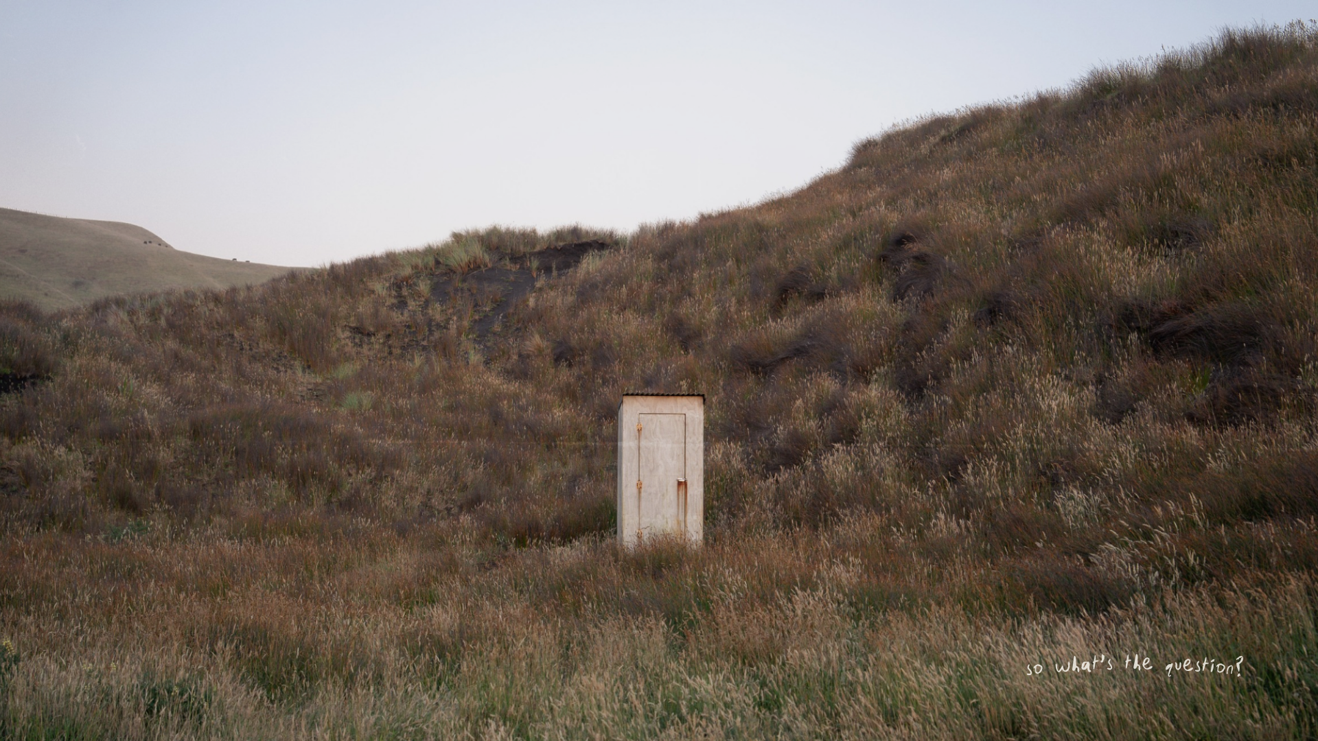 Cinematic landscape photography of a outdoor bathroom among rolling hills, photographed by Stray Studio.