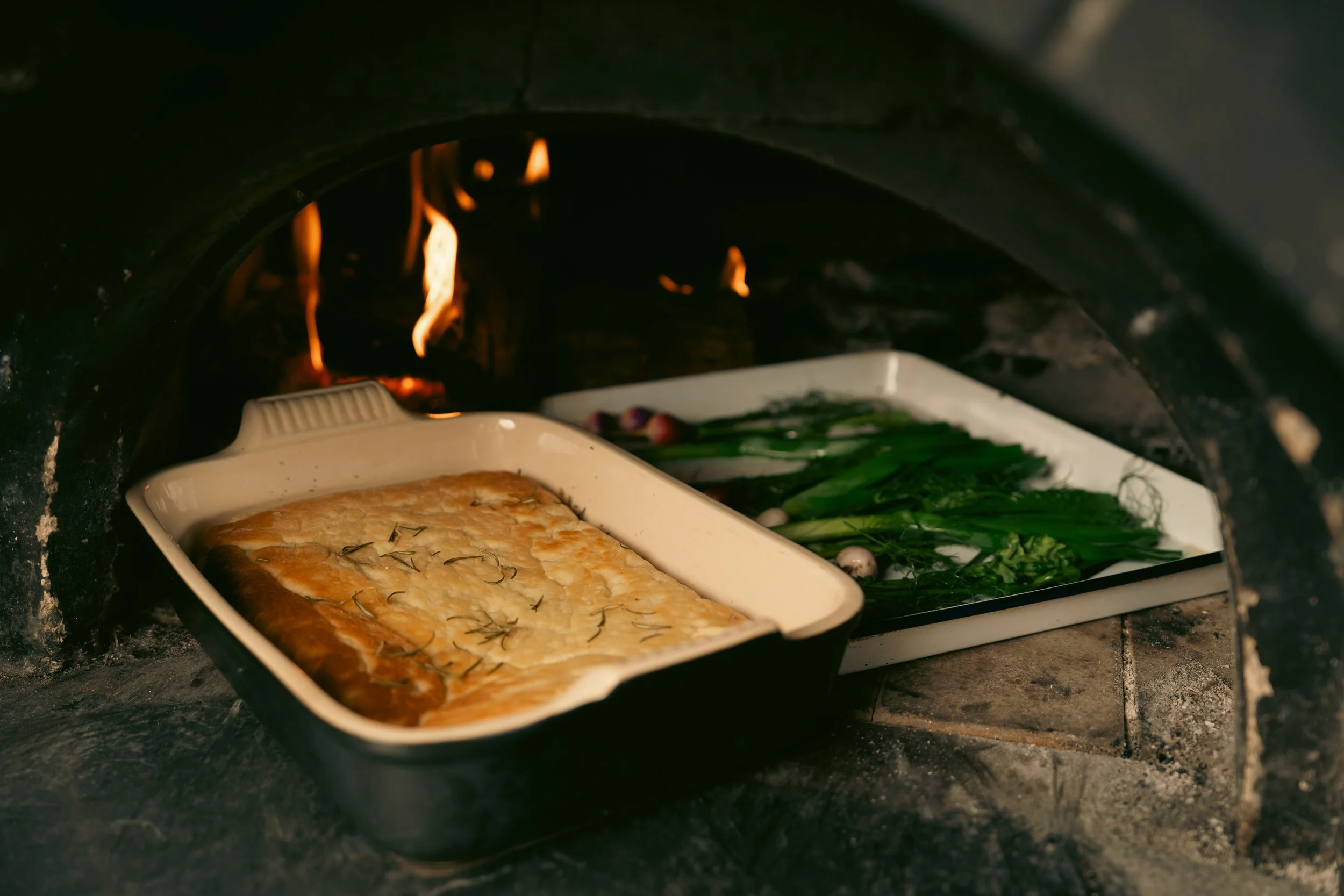 Fresh ingredients cooked over fire as part of the Elora Fine Farming farm-to-table experience.