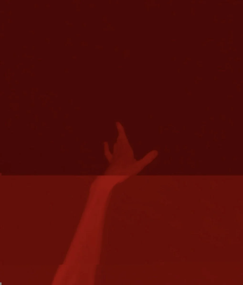 Hand bathed in red lightning.