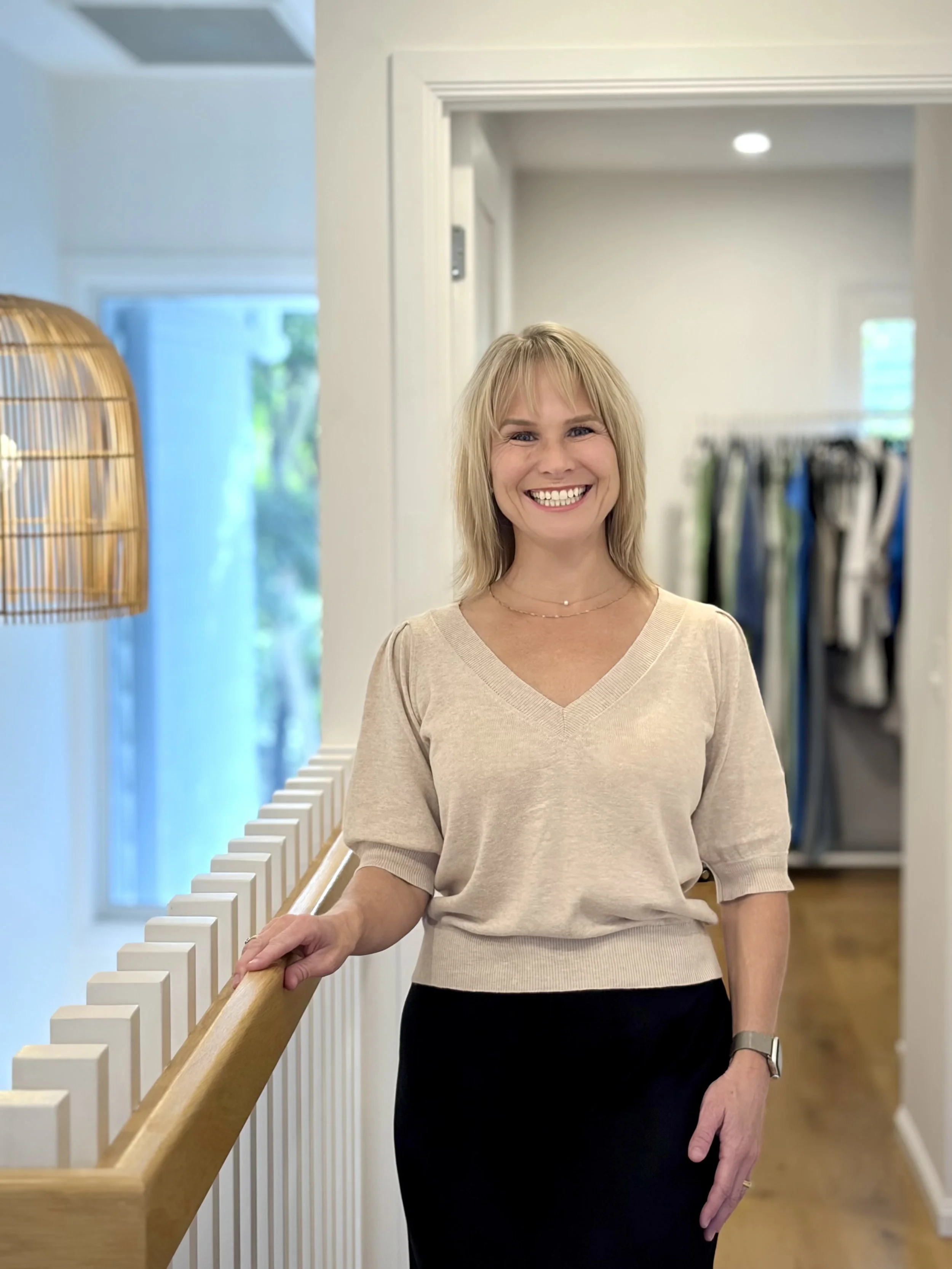 Karlie, administration and sales at Louise Wilkinson Agencies, standing in the LWA showroom near the boutique fashion racks.  Karlie | Administration & Sales — Louise Wilkinson Agencies