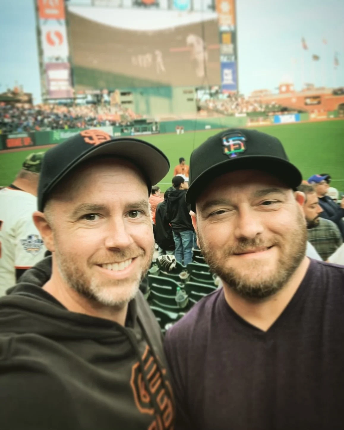 Michael and his husband Daniel at a San Francisco Giants baseball game