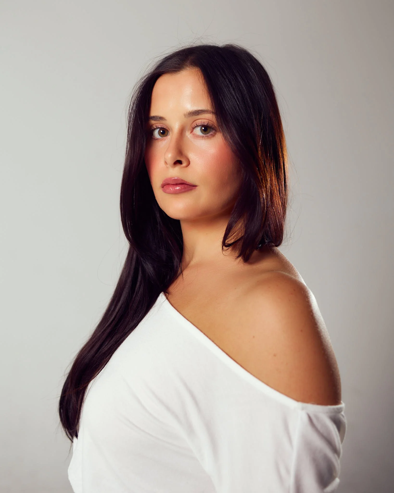 Natural beauty portrait of female model in white off-shoulder top photographed for a Denver modeling portfolio.