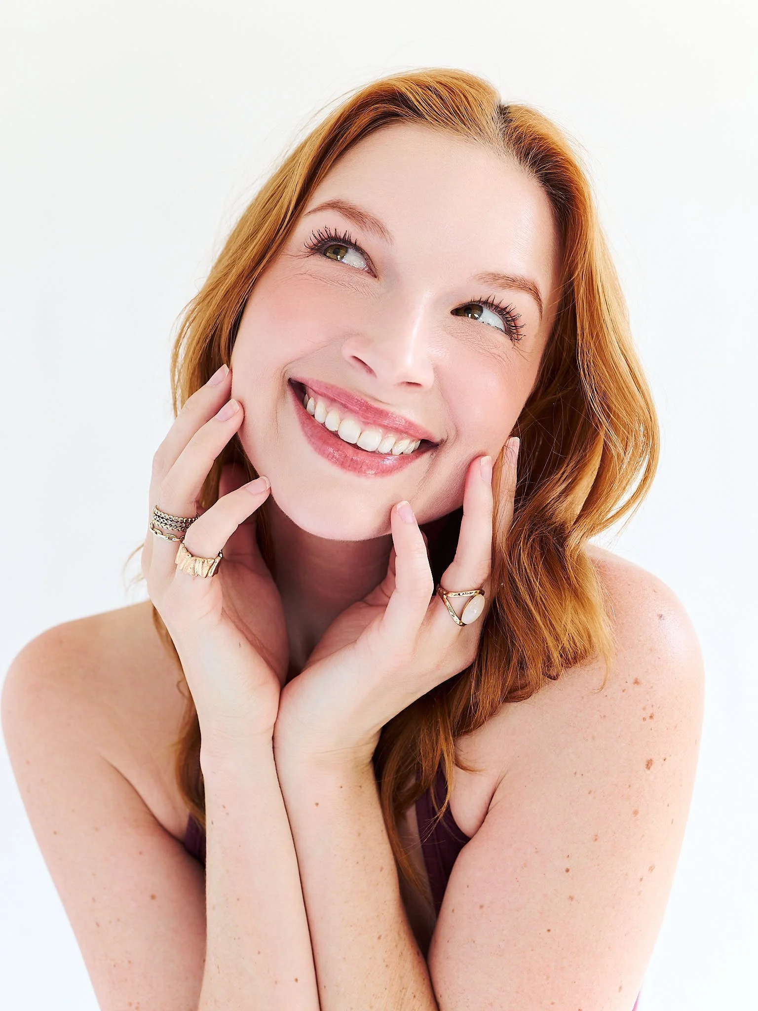 portrait of red head woman in front of off white backdrop for her model development photography session in LA California