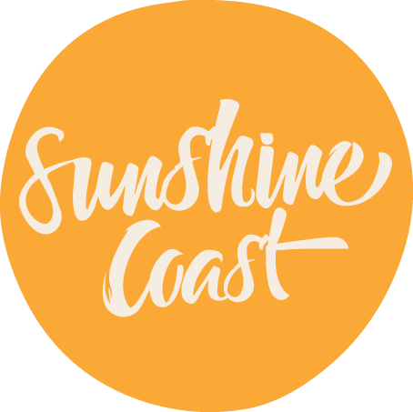 Orange circle with white cursive text that says "Sunshine Coast".