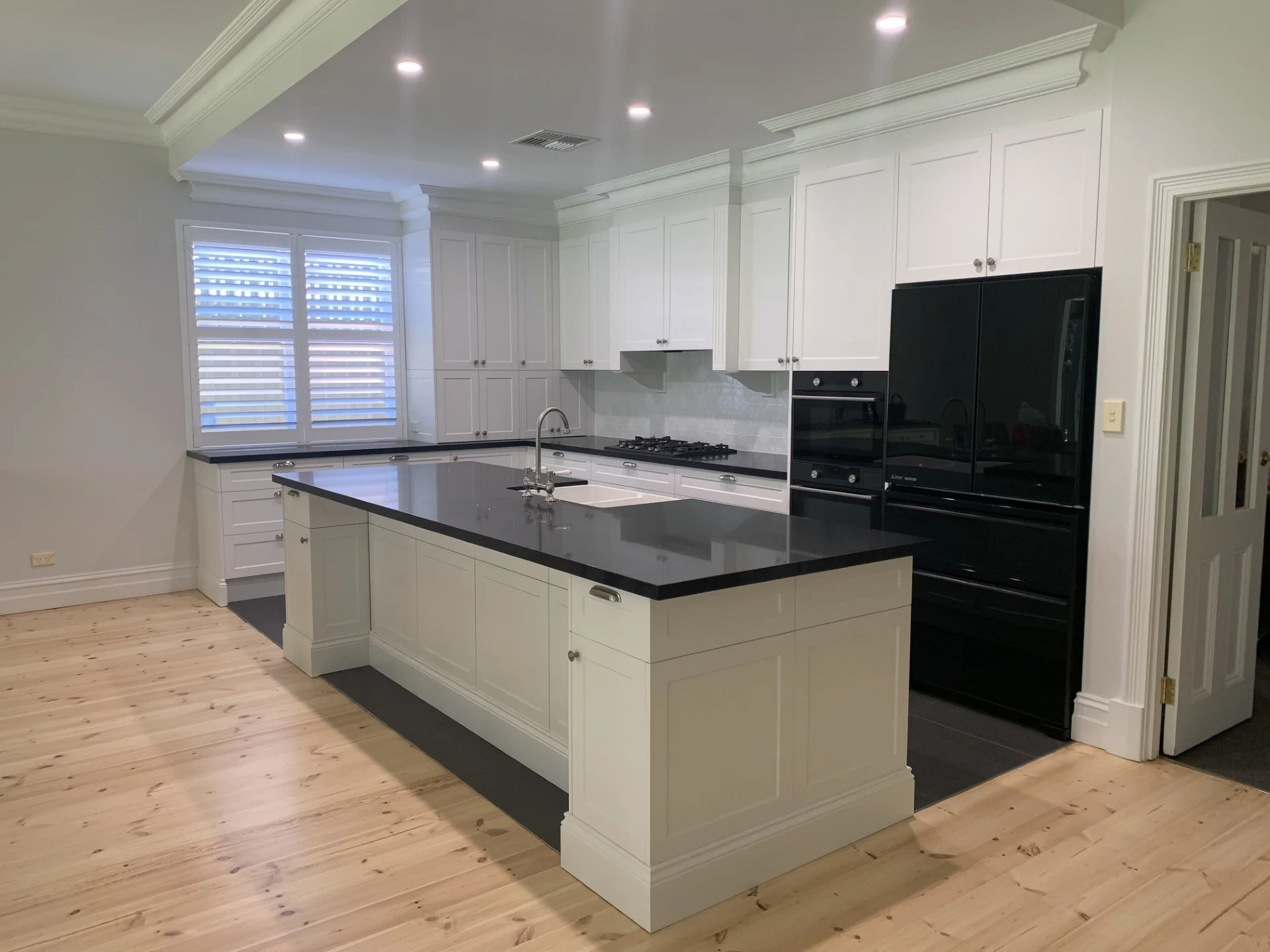 Large island with shaker doors and shell ornate handles.