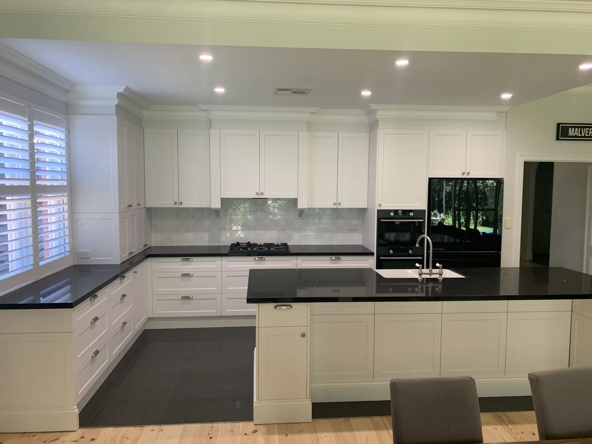 Stunning character style kitchen, shaker doors black granite benchtops, feature tiled splashback.