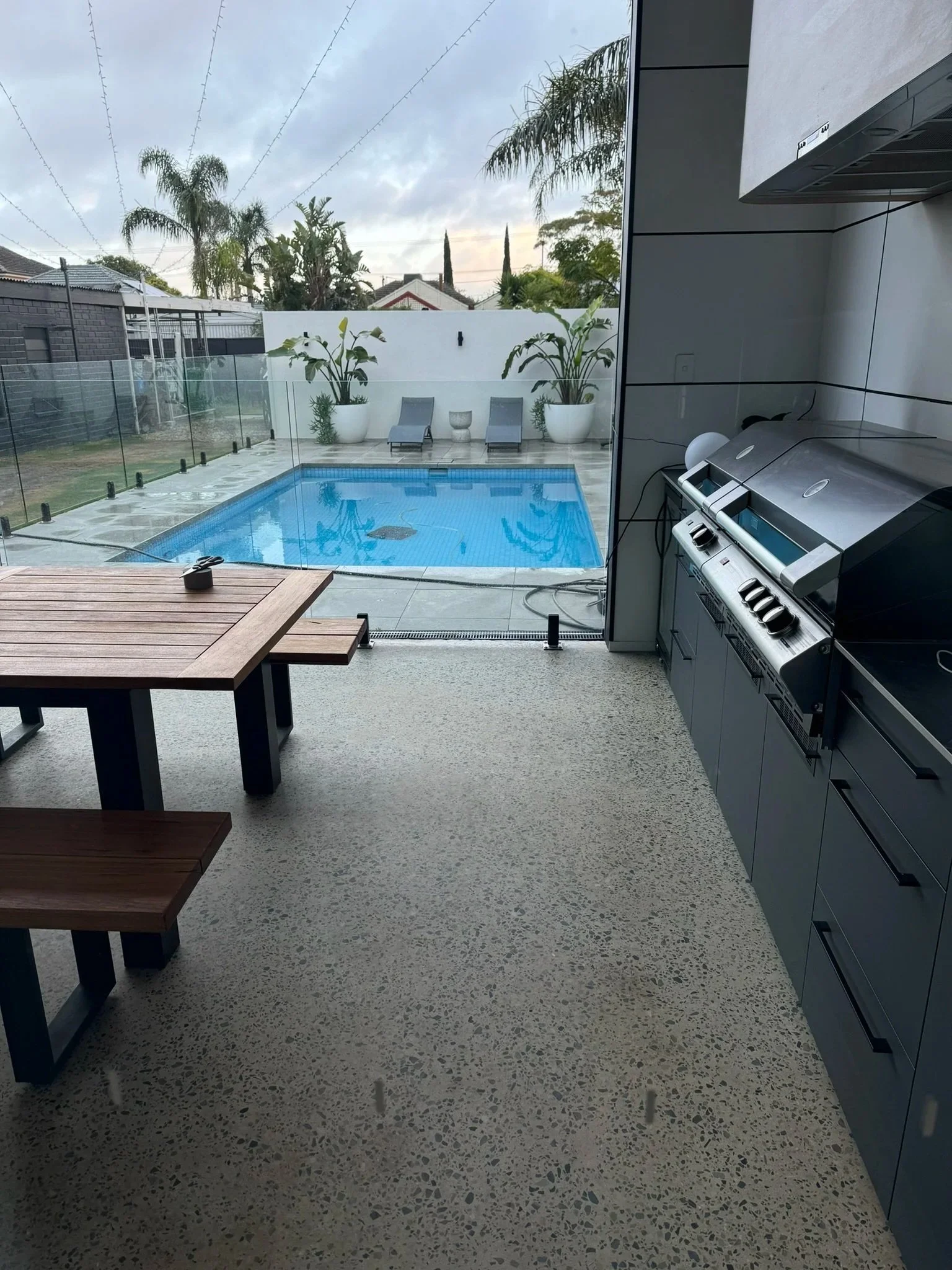 Alfresco area attached to the new extension living area, leading on to the pool all at the same level given the space depth.