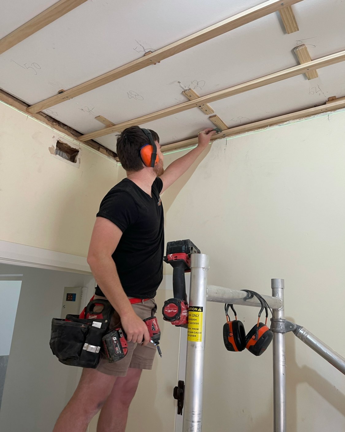 Battening down the ceiling space to give it a new look which is perfectly level for the ceiling tiles to finish up to.