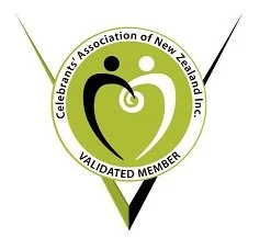 Logo of Celebrant's Association of New Zealand Inc., with a green and black circular design featuring two stylized human figures and a checkmark, indicating a validated member.