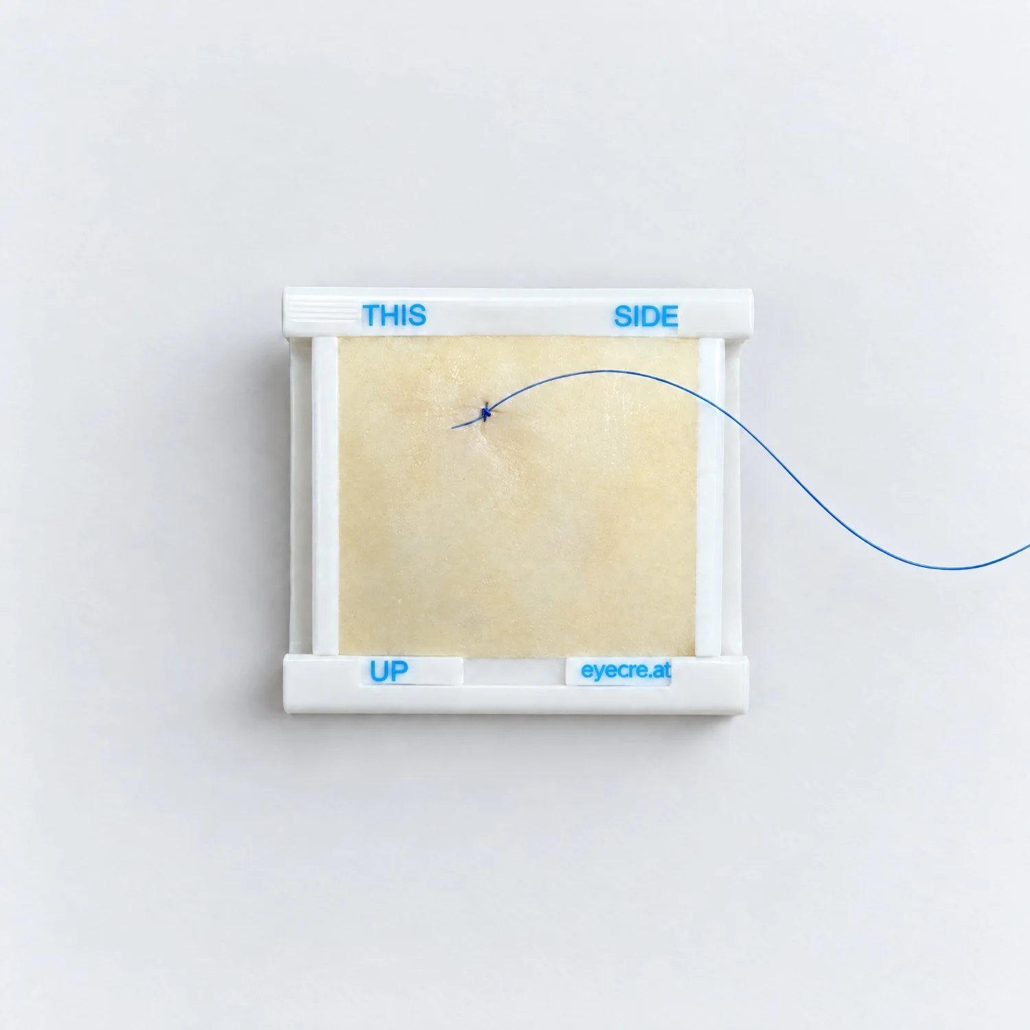 Placed conjunctival suture with knot on the Pad 4 ConjSuturing, close-up, eyecre.at