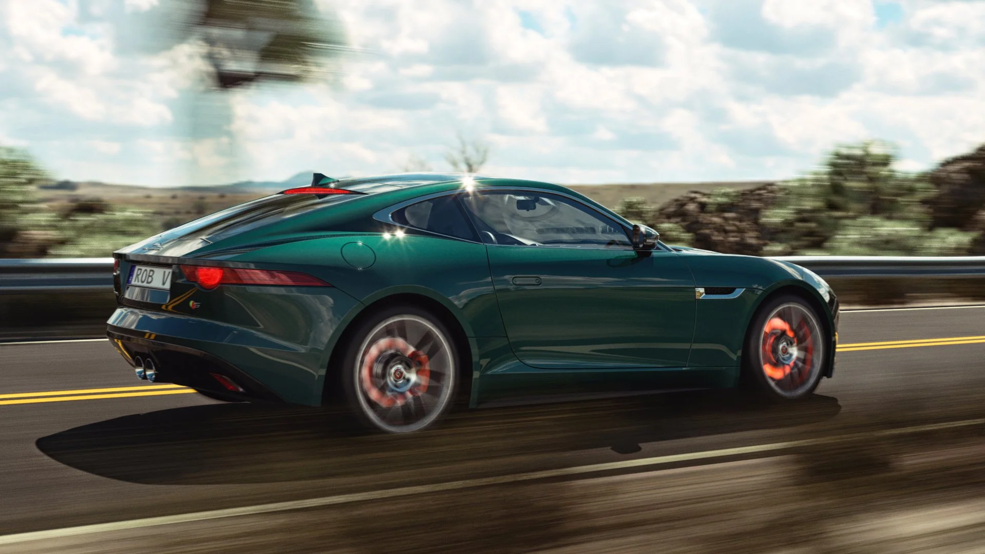 3D automotive CGI of a Jaguar F-Type driving on a desert canyon road, featuring realistic daylight environment, motion blur, and glowing red-hot brake rotors - Valenzuela Creative