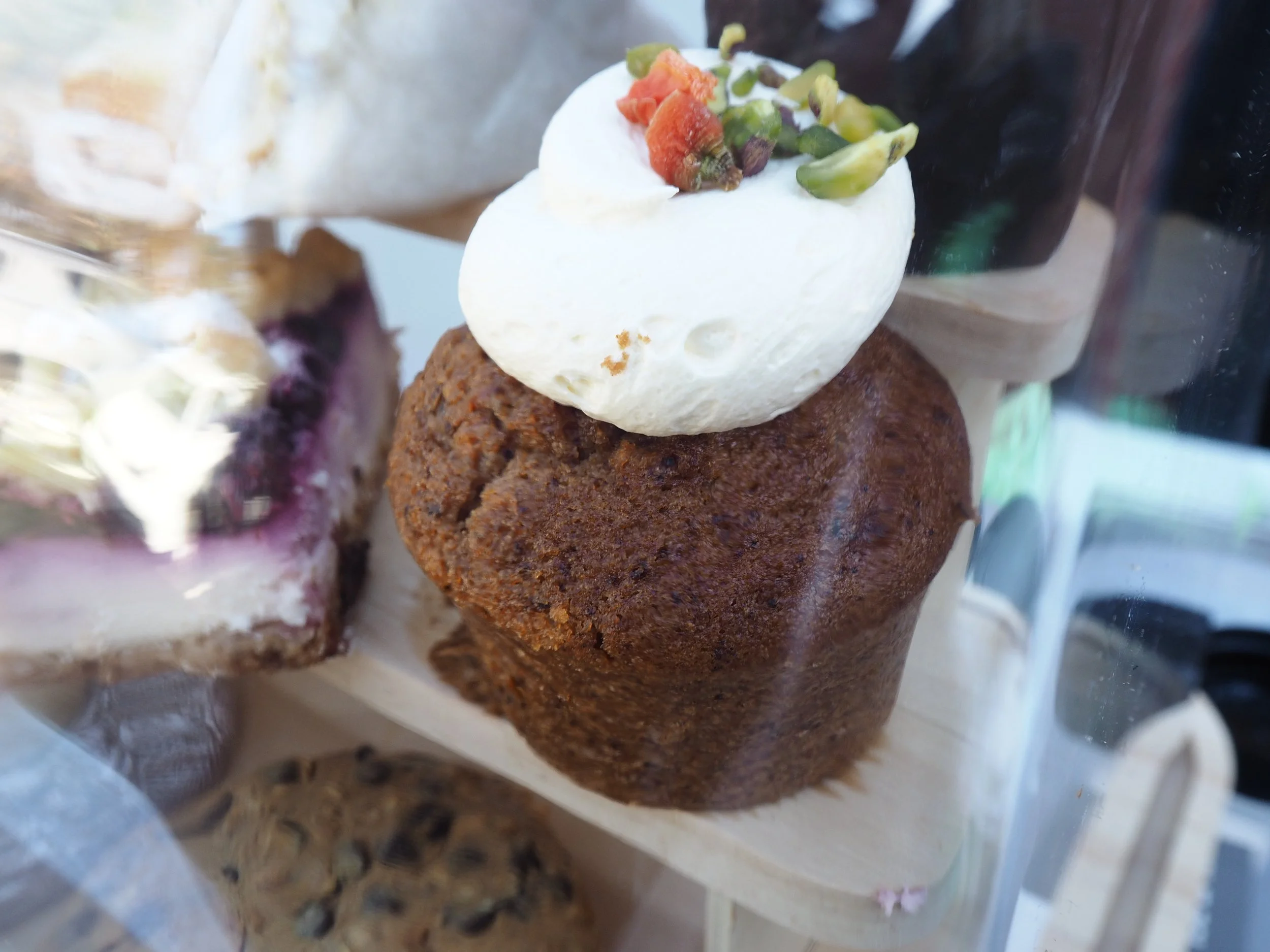 A carrot cake cupcake on display at a food stall