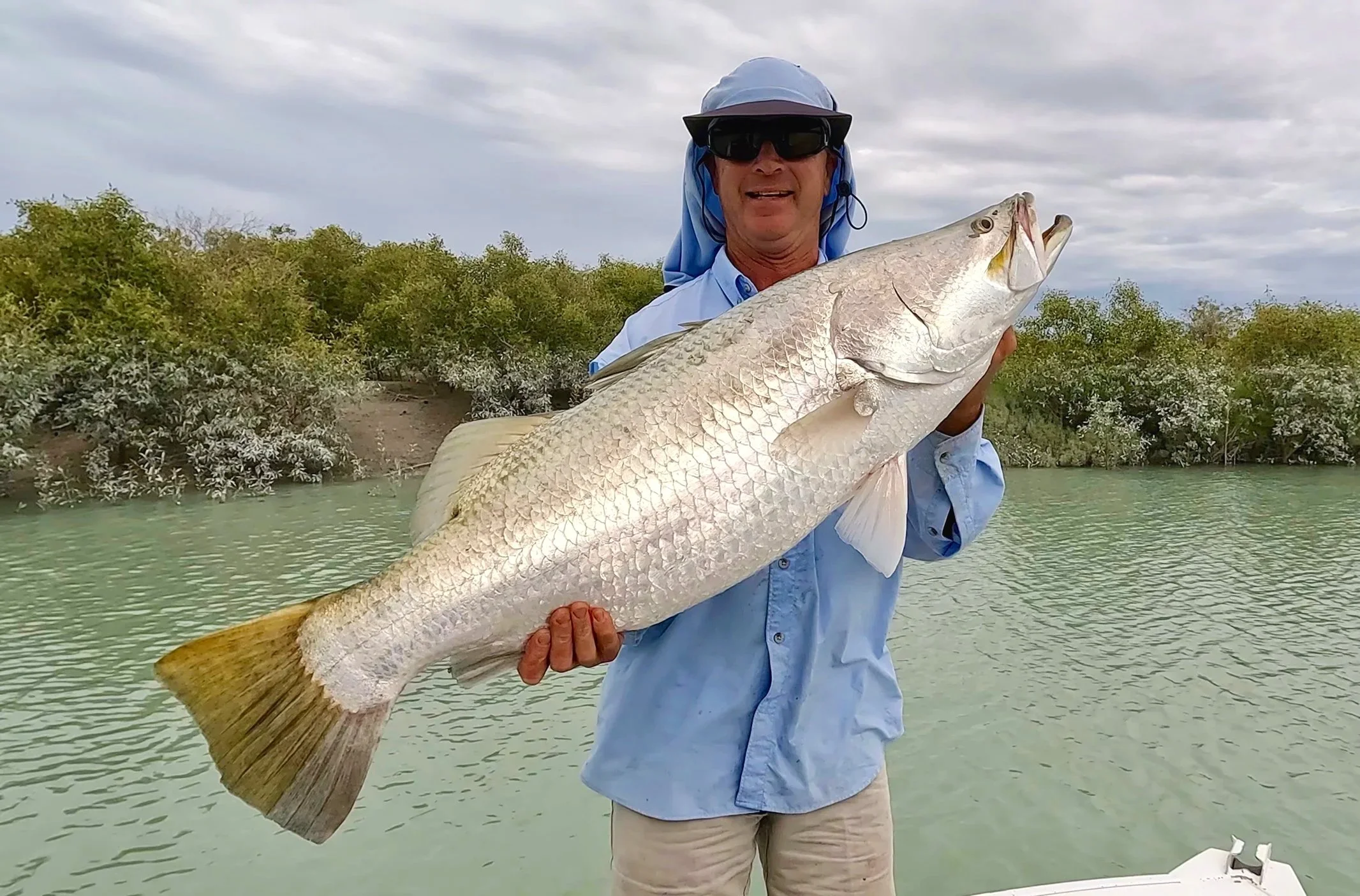 Local Broome Fishing guide with metre long barramundi, caught creek fishing in Broome, WA.