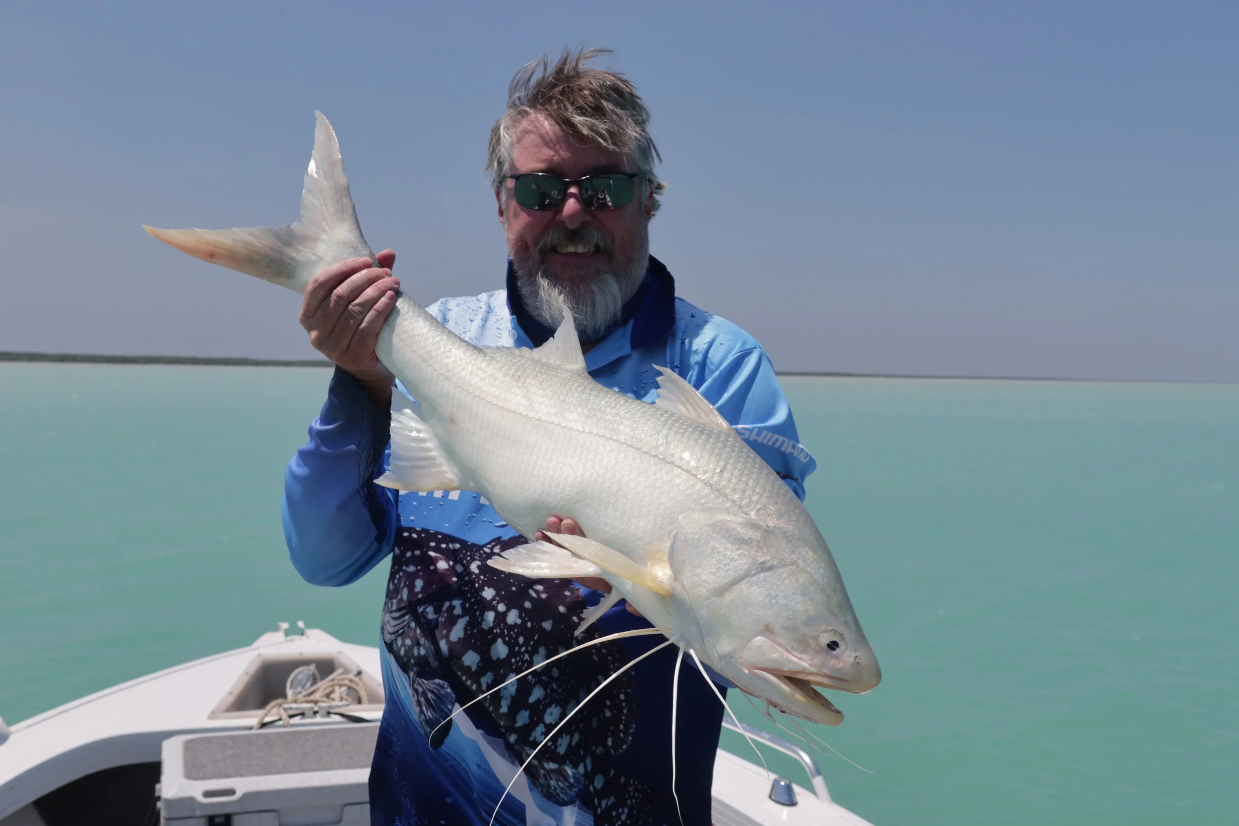 Fisherman holding up large threadfin salmon