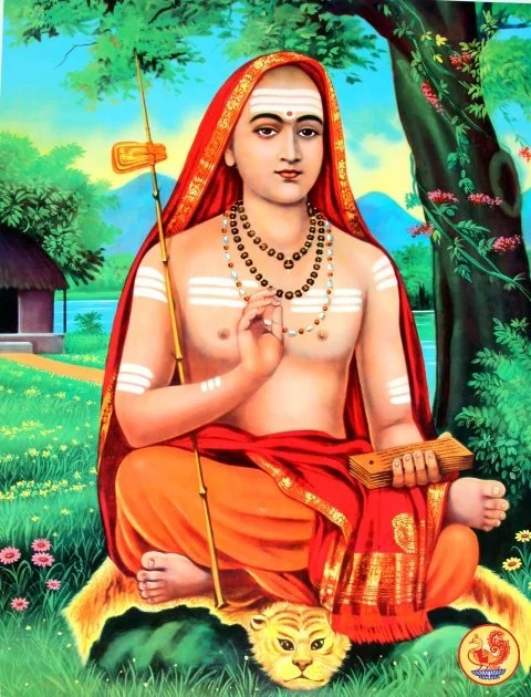 Hindu saint or deity with a serene expression, seated outdoors on a tiger skin, holding a scroll and a staff with a flag, surrounded by lush greenery and a river in the background.