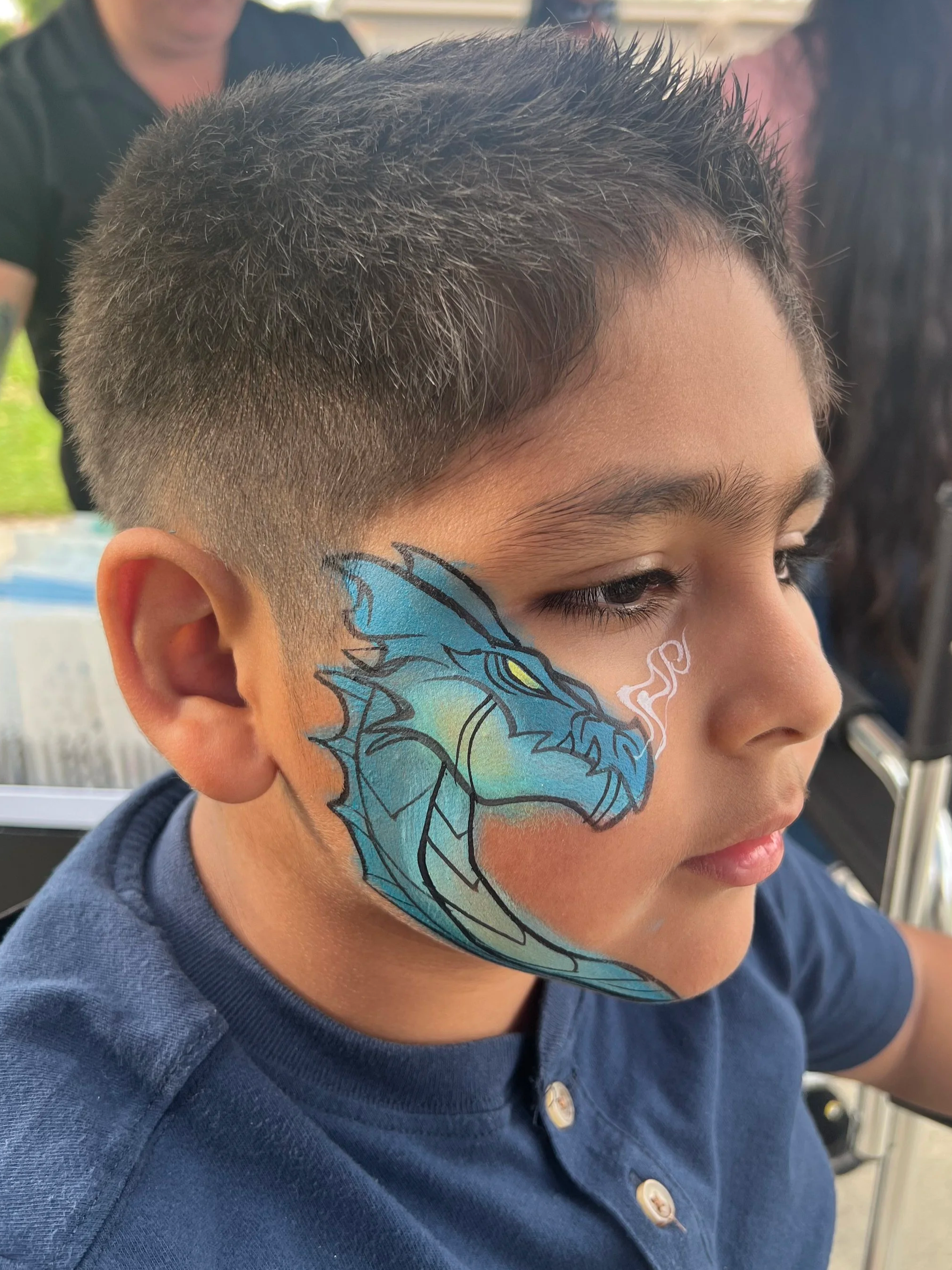 Fierce dragon face painting designs, perfect for kids' birthday parties, festivals, and special events in Los Angeles. From fierce, fire-breathing dragons to fun, colorful mythical creatures, we use high-quality, skin-safe paints to bring your favori