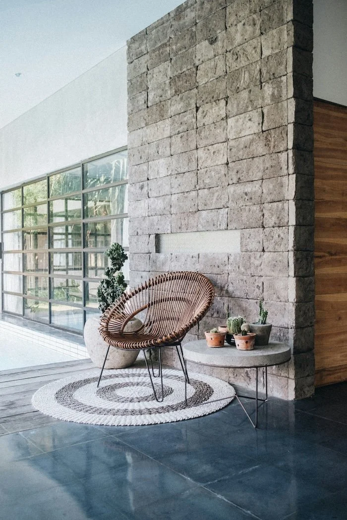 Interior corner with a rattan chair and decore for a Bend  Buyers real estate agency photo on their website.