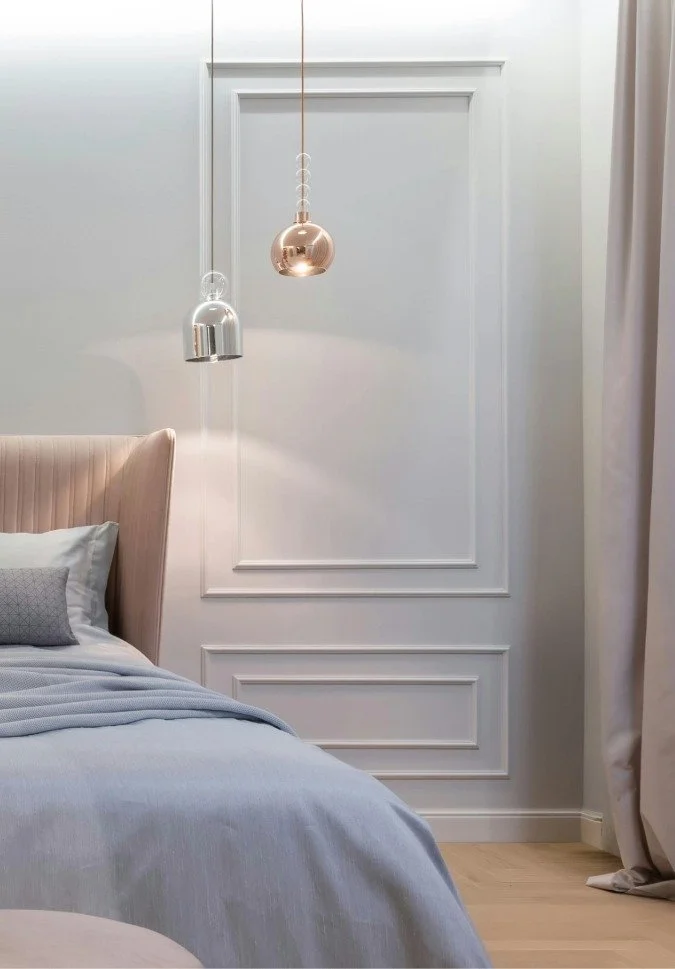 A bedroom corner with a headboard and comfy bedding for a Bend Real Estate Agency home listing.