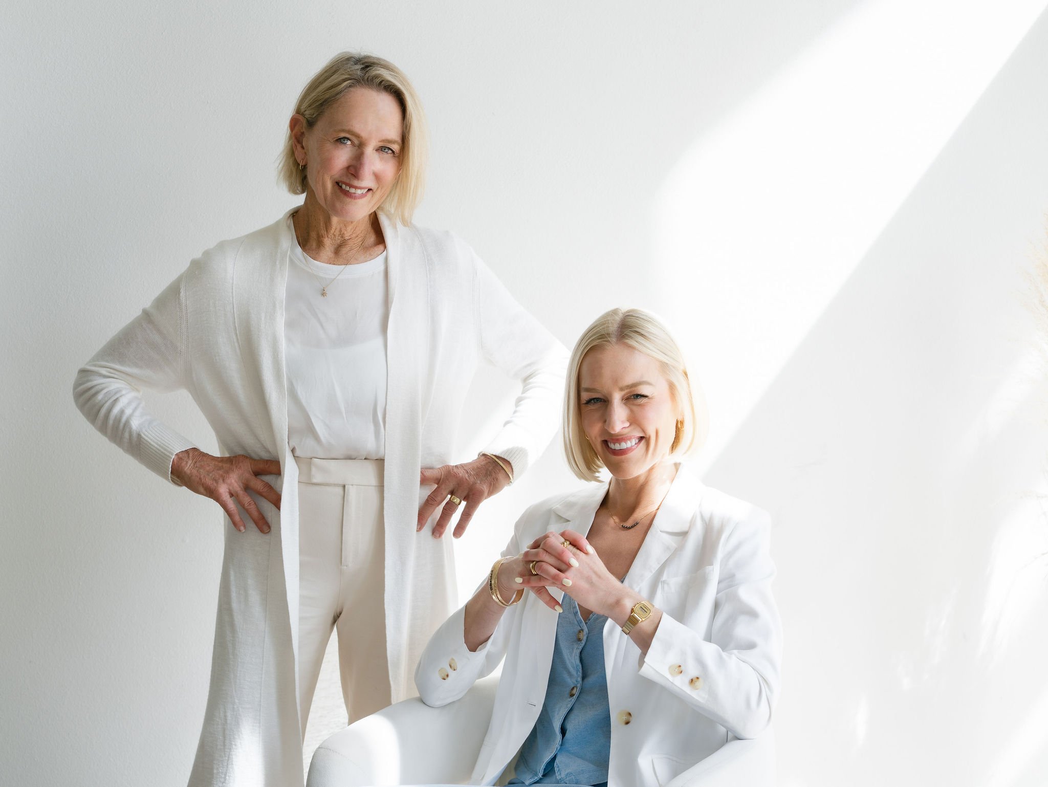 Two women with blonde hair smiling, in white blazers are Bend Oregon Westside Real Estate Agency, The Ortega Collective.