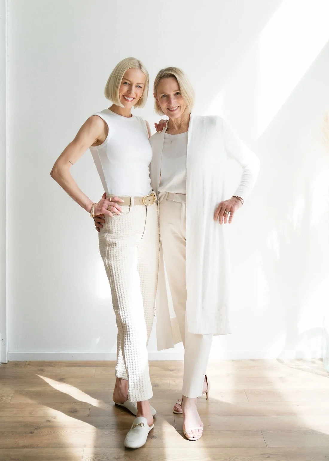 Sherry and Chelsea Ortega, a Bend Real Estate legacy agency, standing together in matching neutral and white outfits.