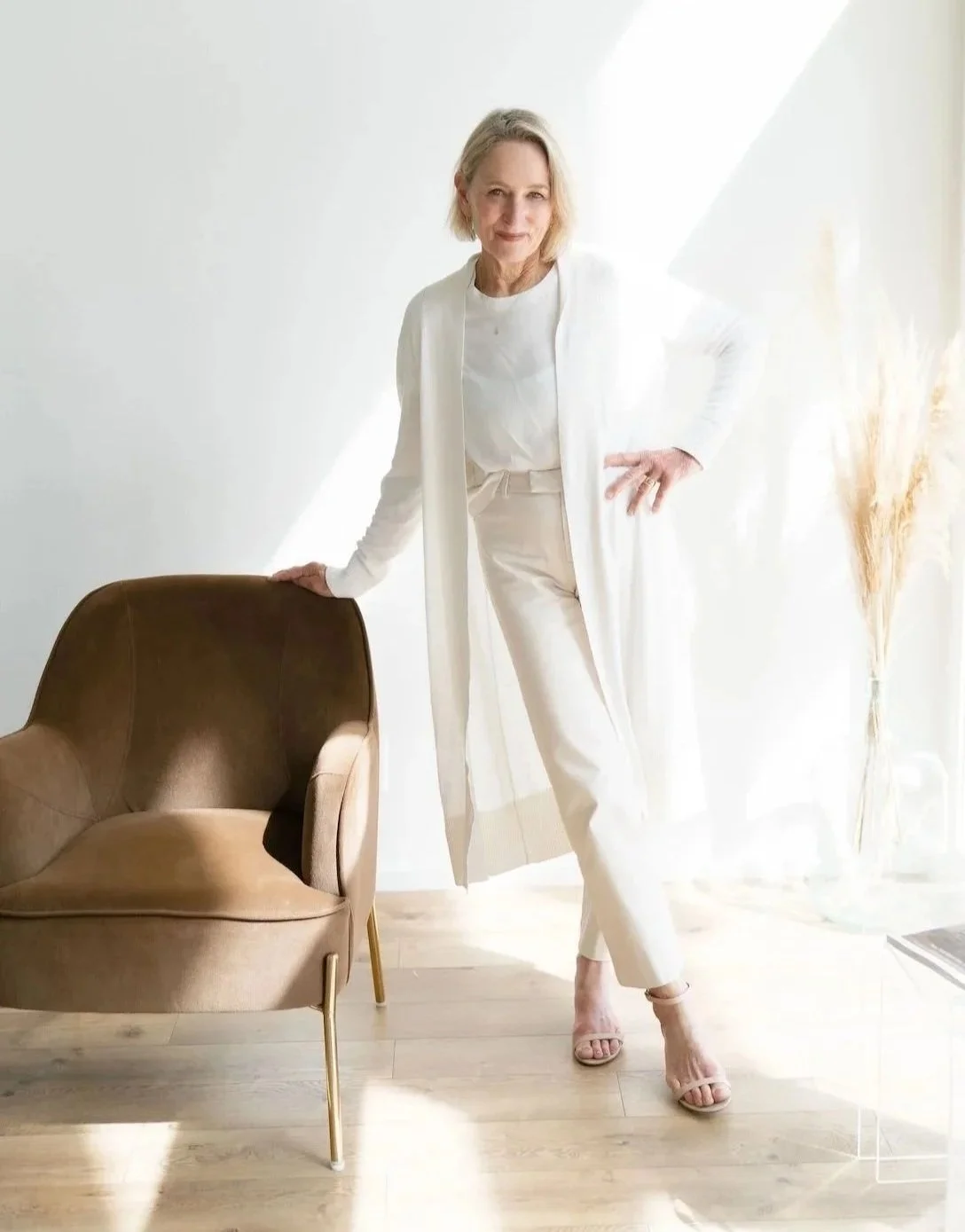 A woman with blonde hair wearing a white outfit is Sherry Ortega, an experienced Real Estate Agent in Bend Oregon.