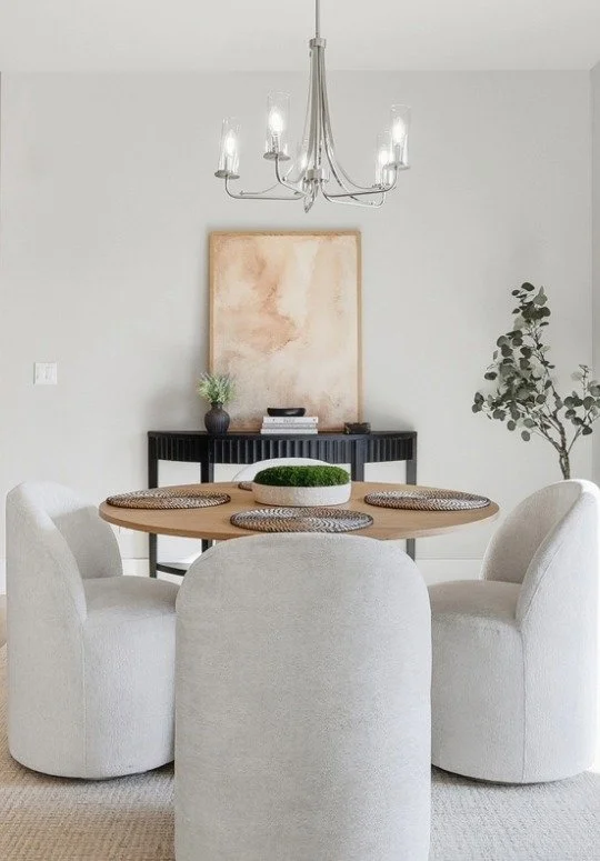 A bright dining room with a round table for a Bend Oregon Discovery West Home listing by Bend Westside Real Estate Agency.