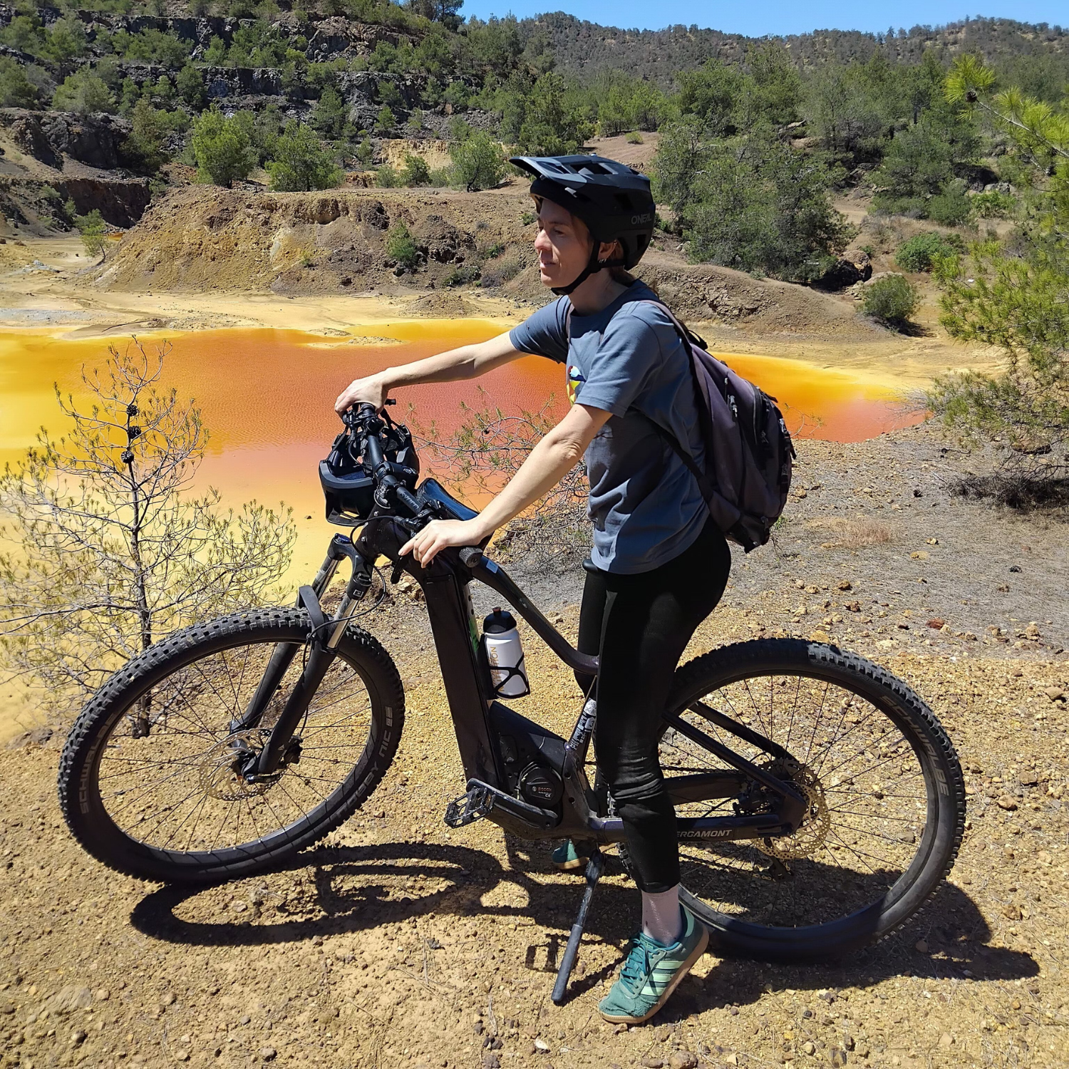 Woman on an e-bike near a quarry lake