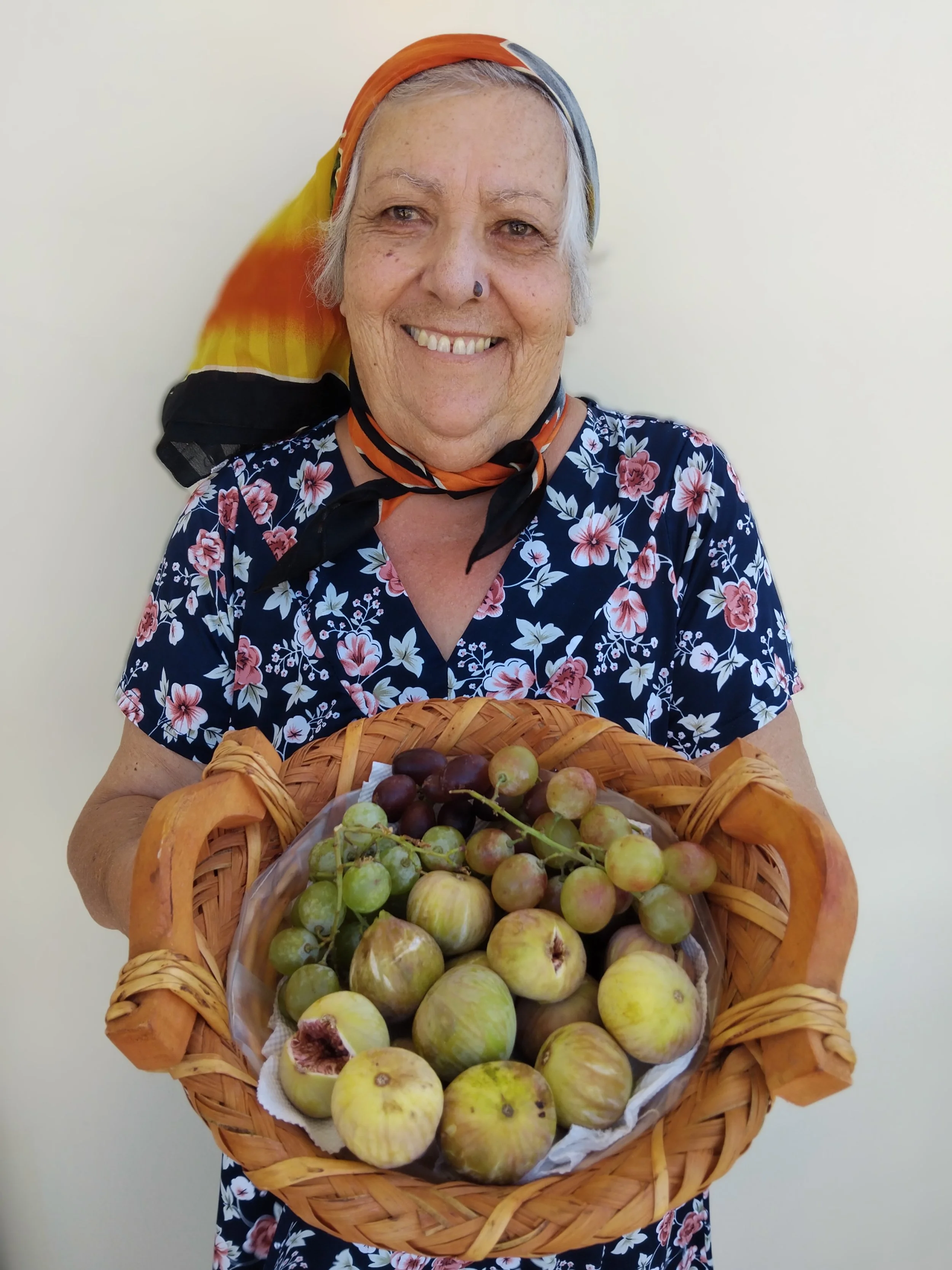 Old lady holding a basket full of figs
