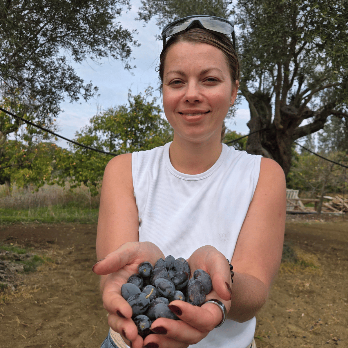 Woman with a handful of ripe olives