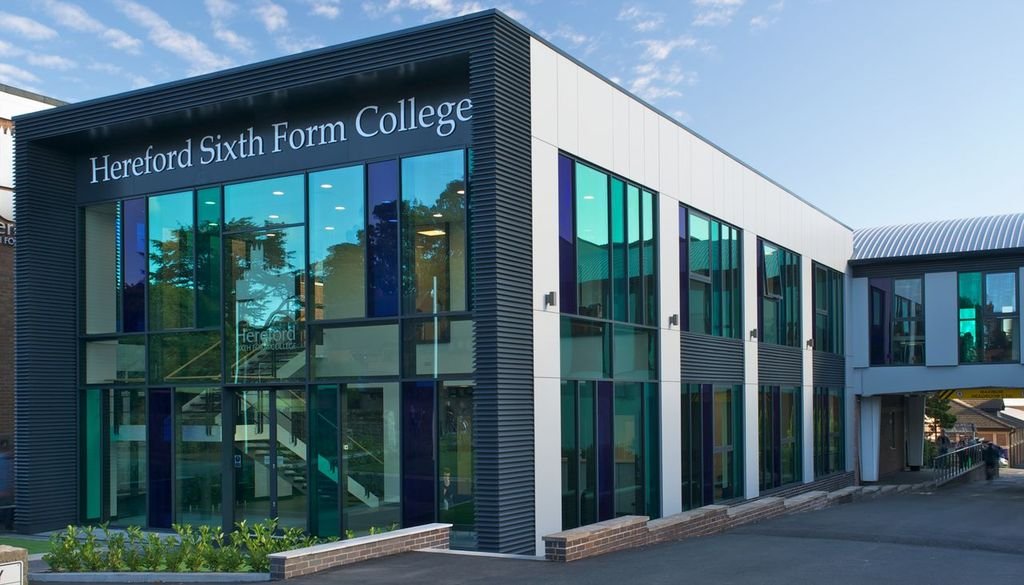 Exterior of Hereford Sixth Form College building with large glass windows and signage on the top left corner.