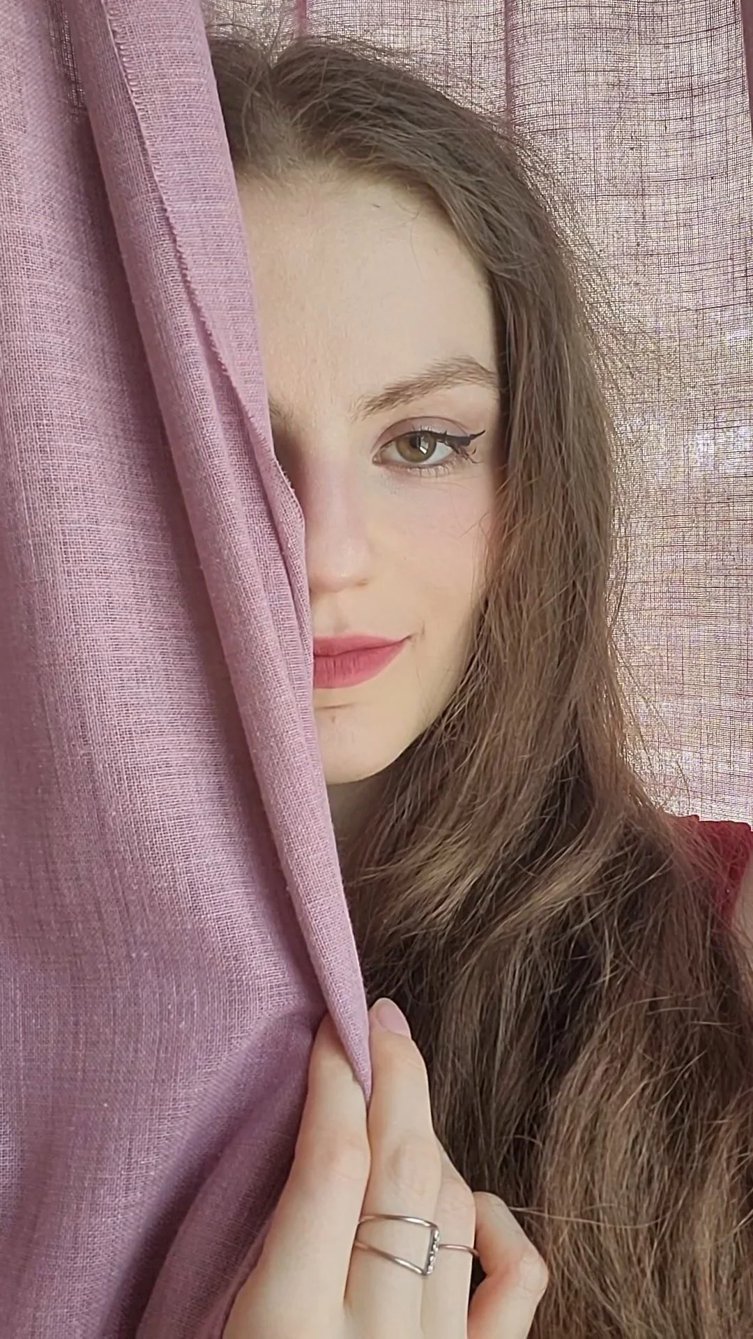 a picture of singer Patty Hago hiding halfway behind a curtain